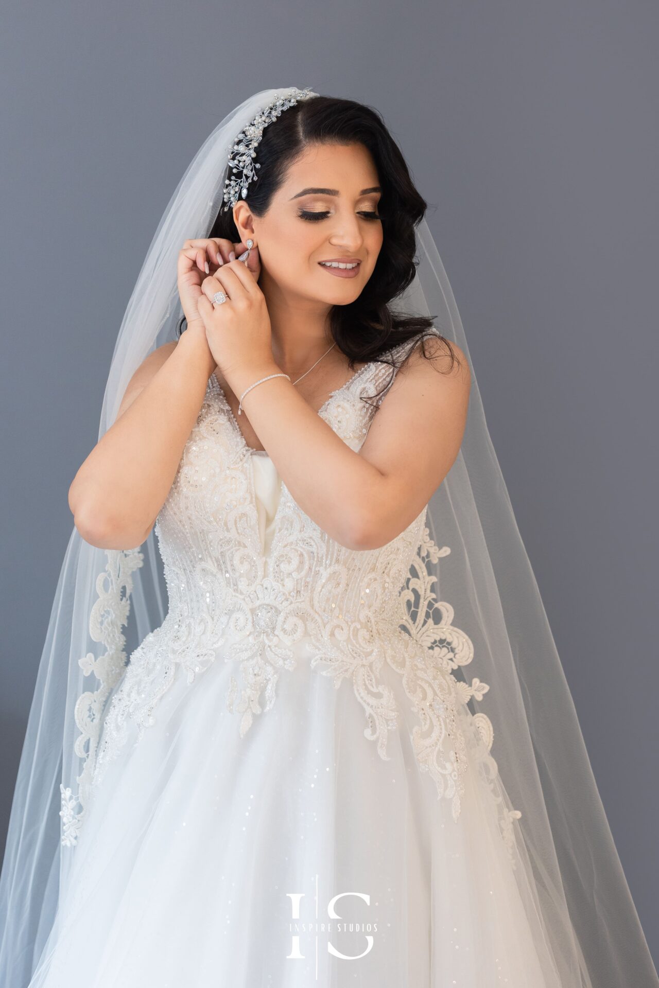 Wedding photographer in London documenting bride's adjusting her earings during her wedding day.