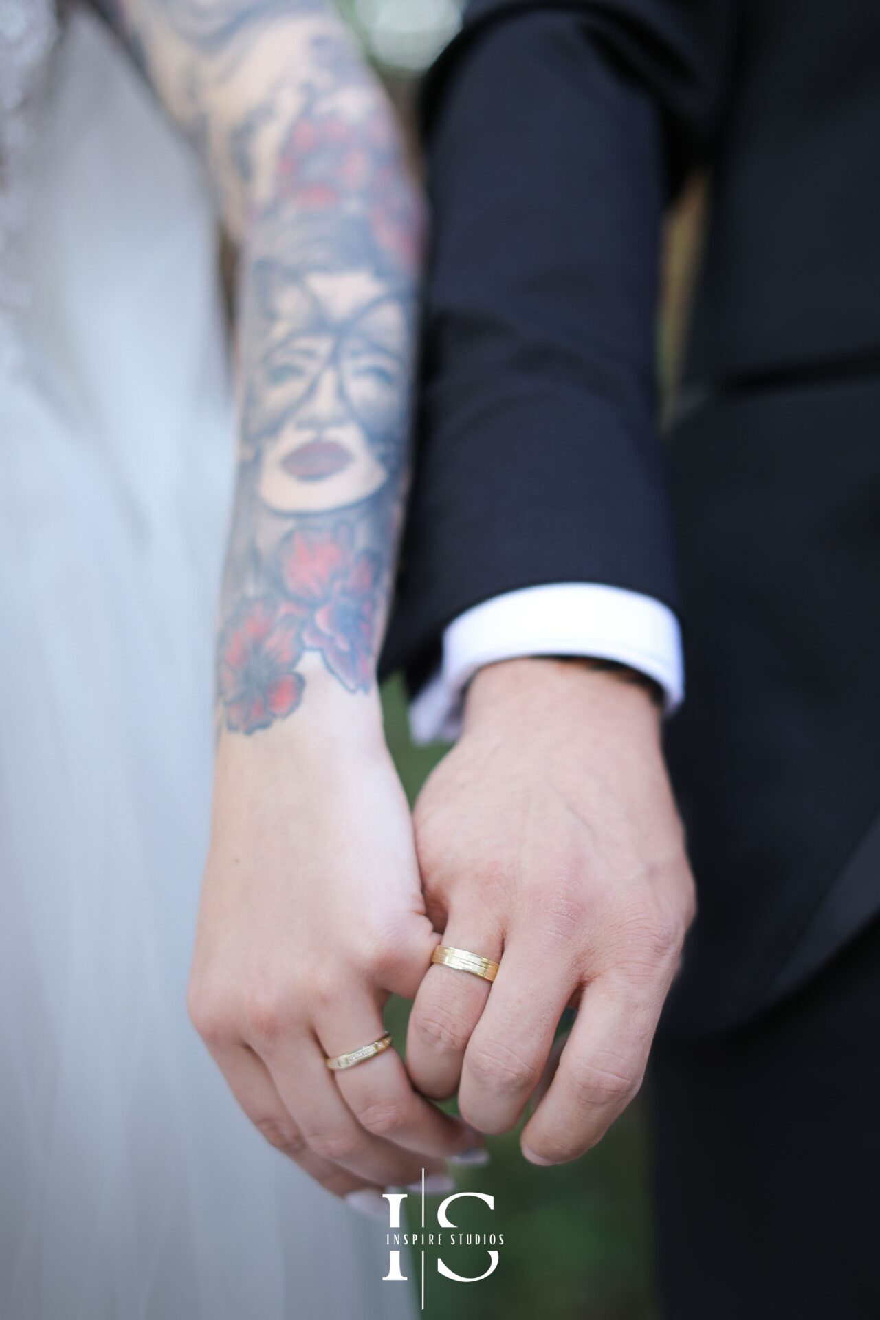 White wedding photography in London of bride and groom holding their hands together after the church's vows.