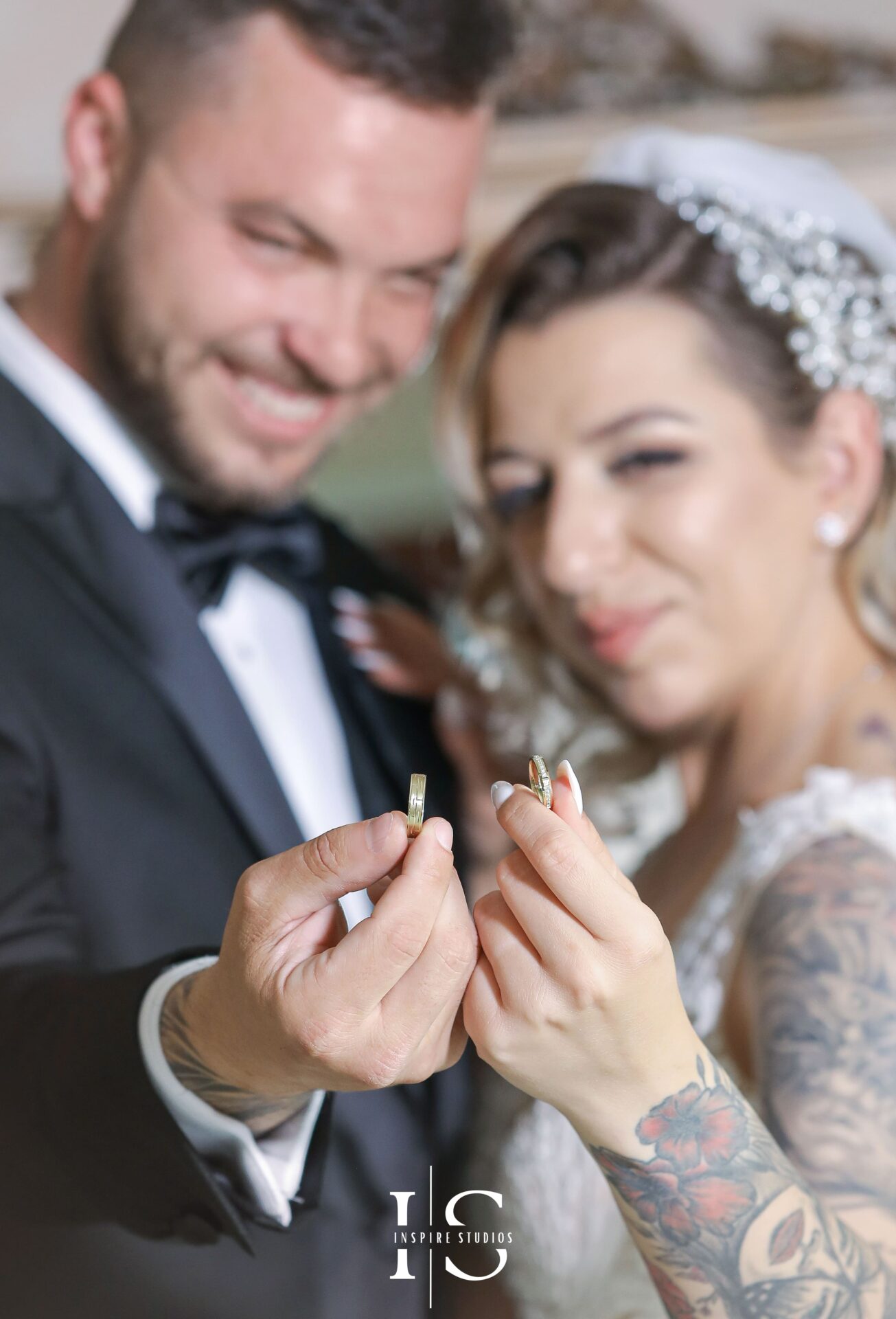 White wedding photography in London of bride and groom hodling their exchanging rings together.