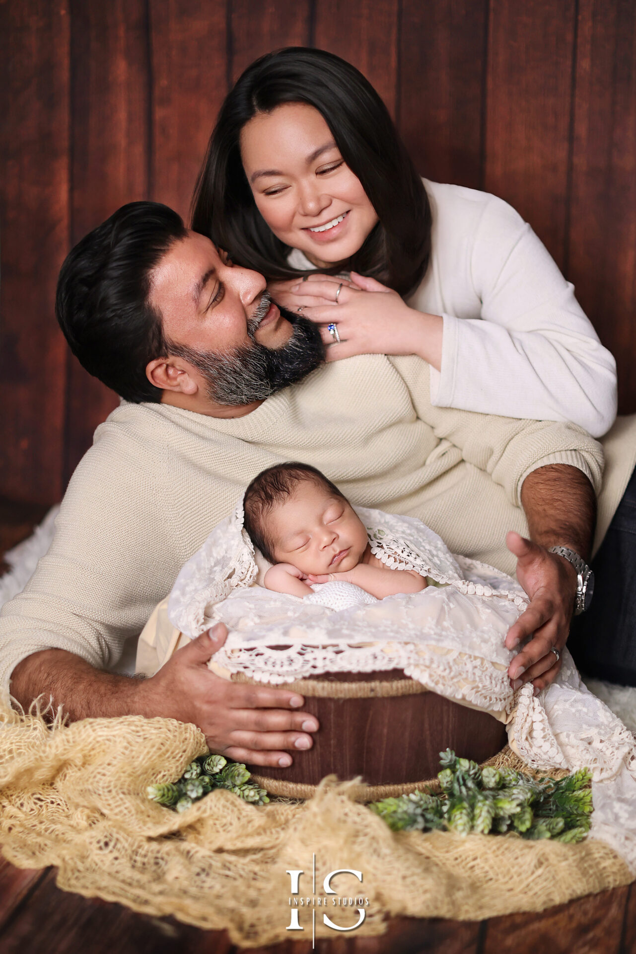 Gentle and professional female newborn photographer in a cozy London studio.