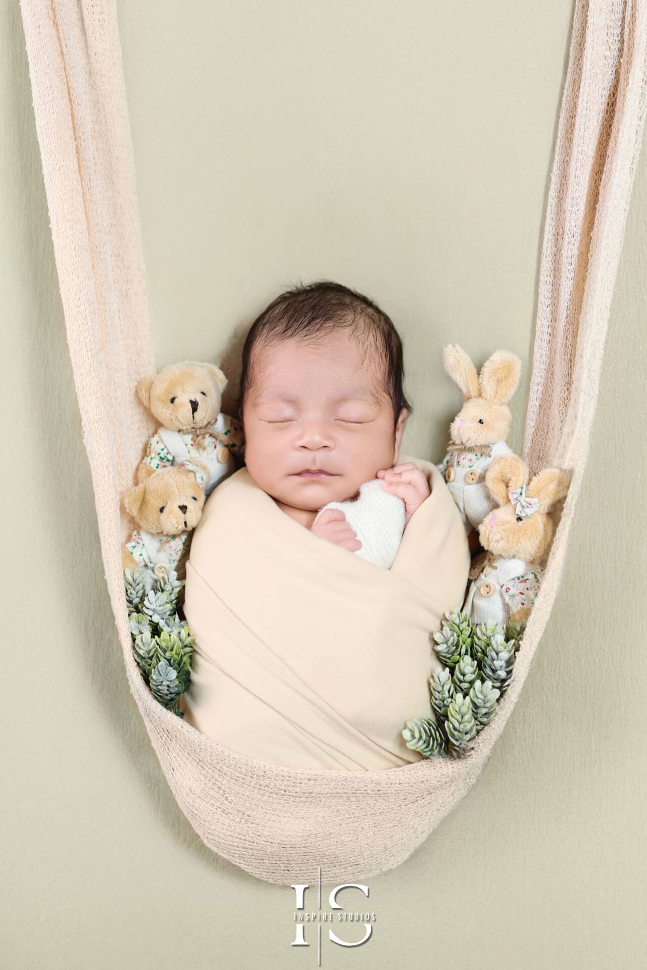 Timeless newborn portrait session in a warm and serene London studio setting.