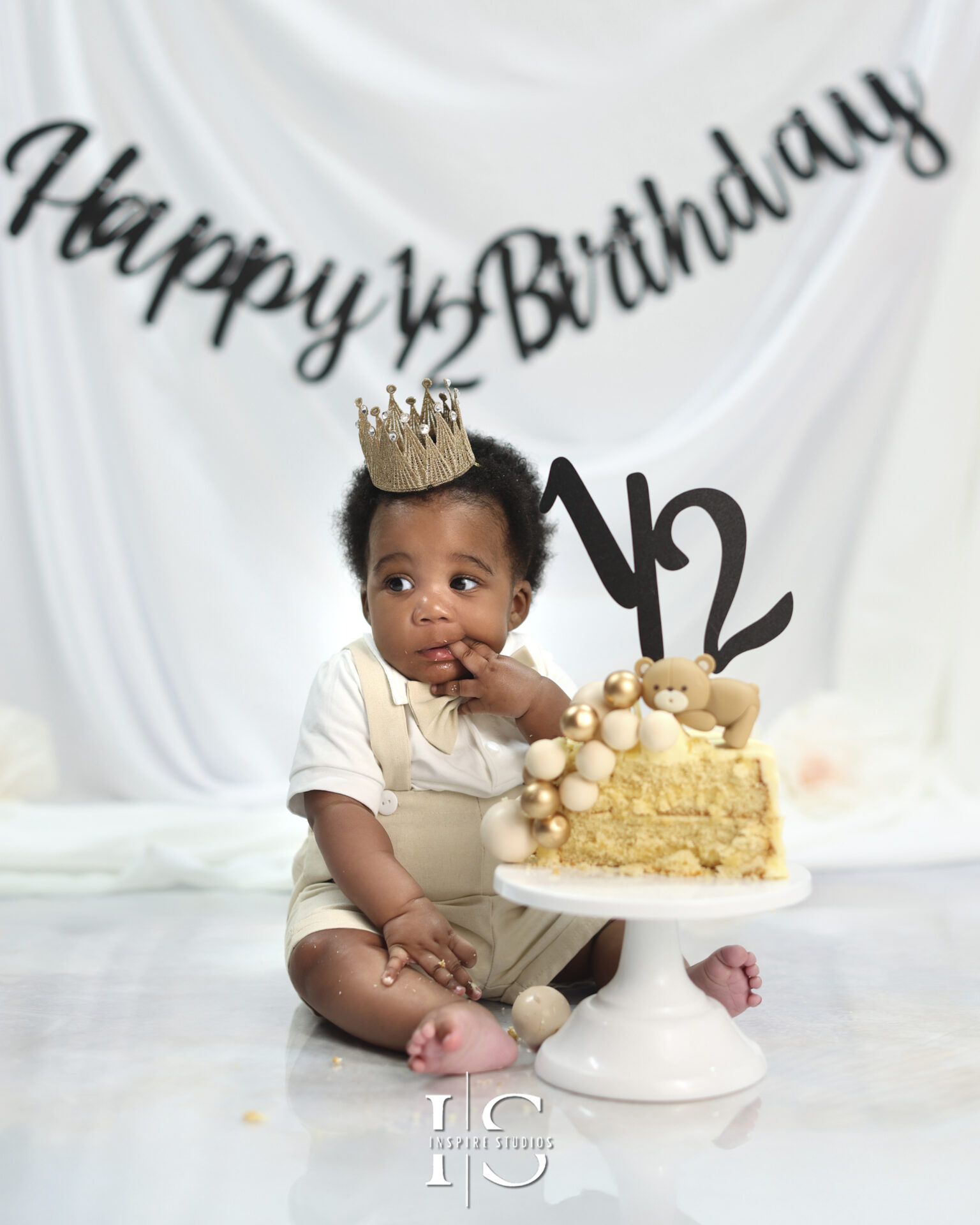 Happy baby in a birthday-themed setup for a 6 months birthday photoshoot.
