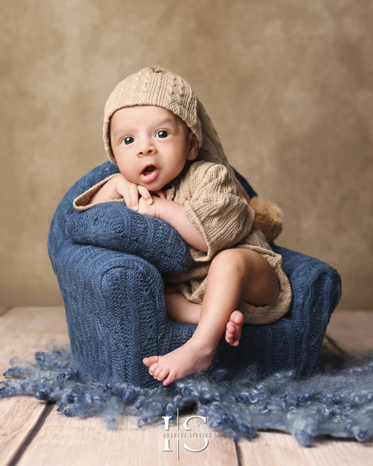 A newborn in a cozy, professional newborn photography session.