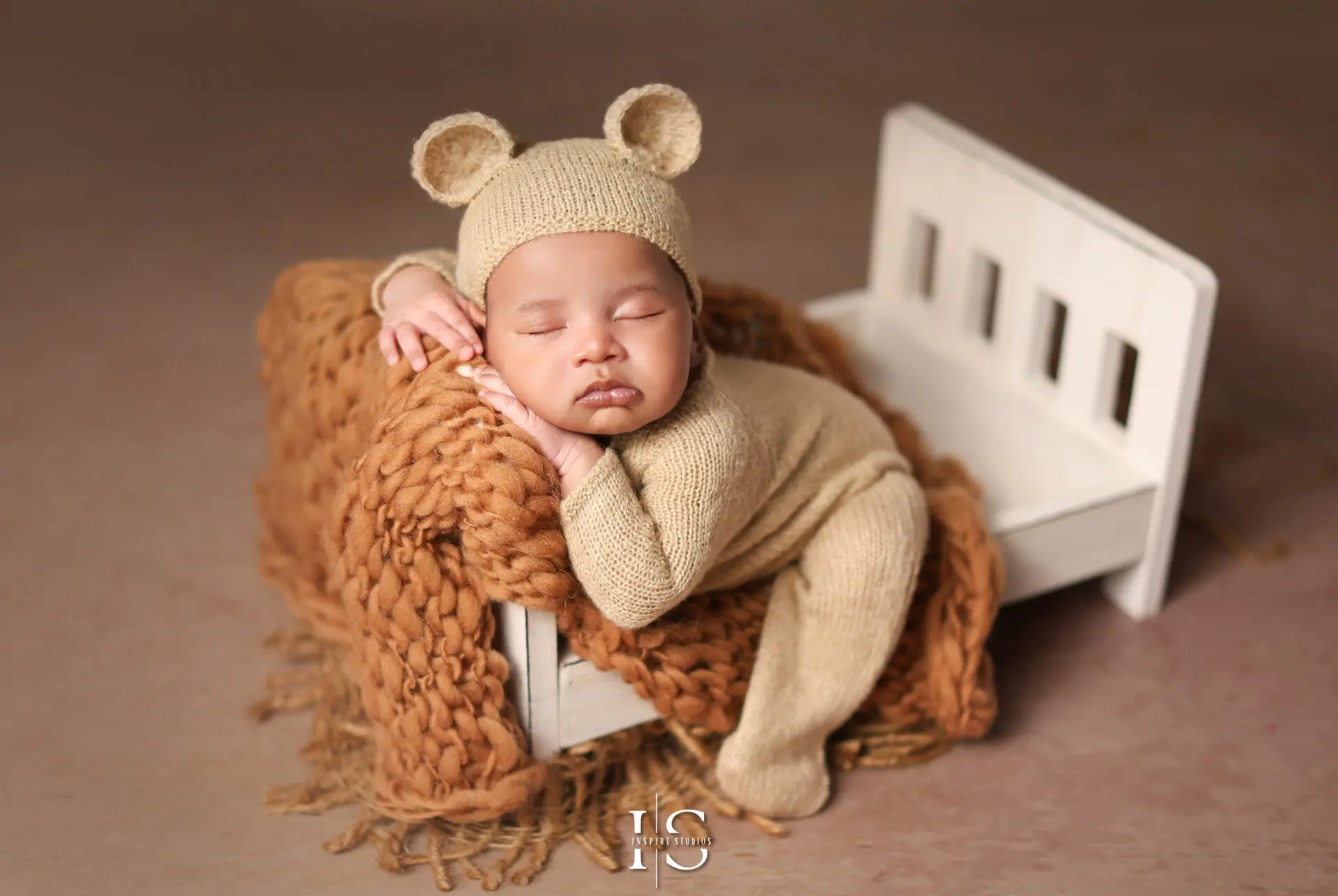 A newborn wrapped in soft blankets during a professional yet budget-friendly photoshoot in London.