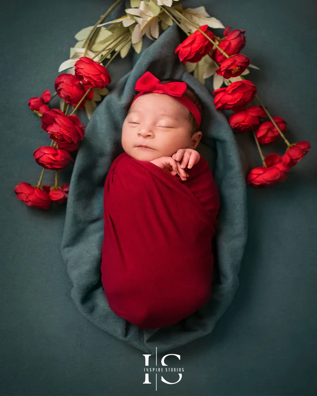 Peaceful newborn baby girl sleeping on a soft pink blanket.