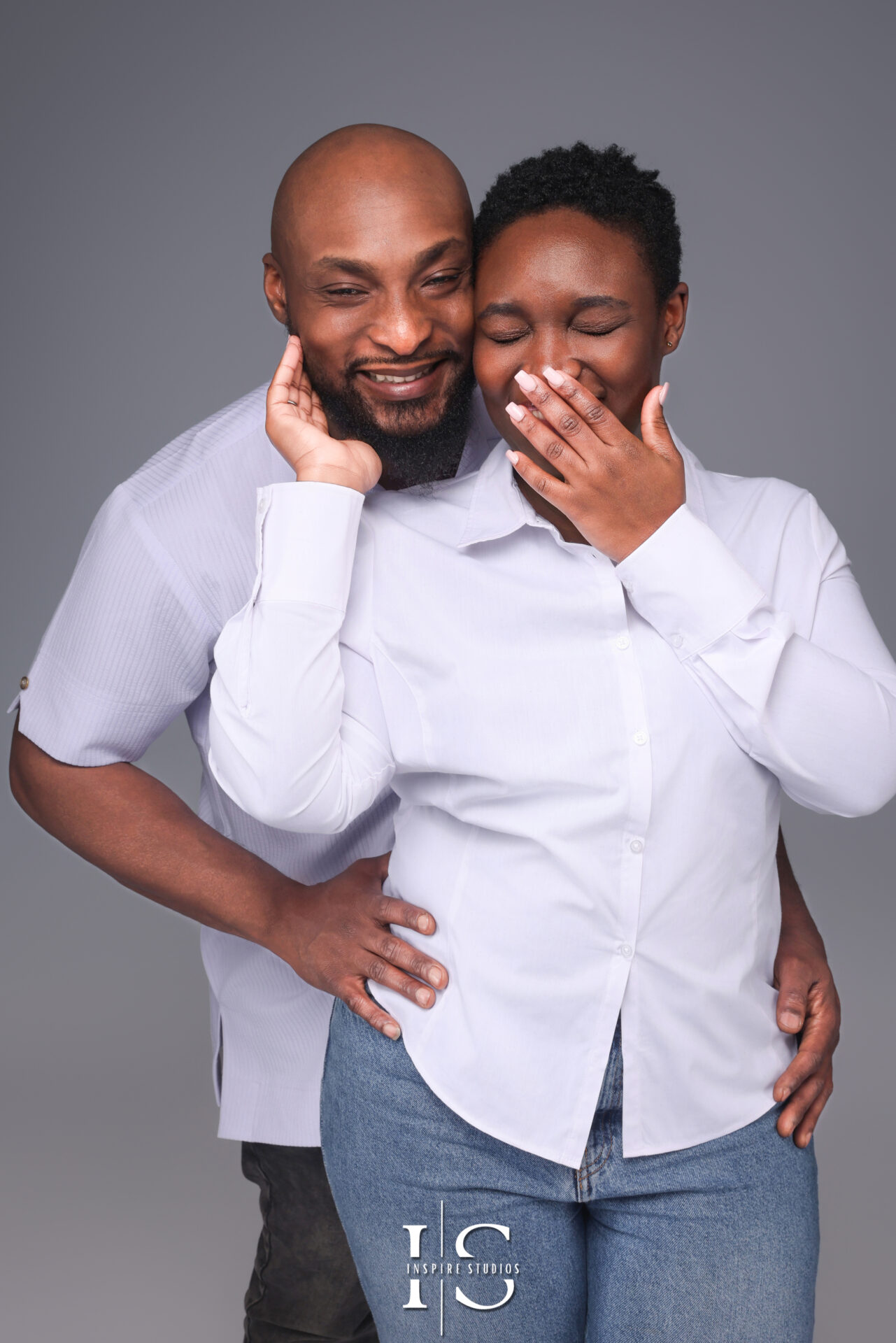 A romantic black-and-white portrait of a couple embracing in a London photography studio.