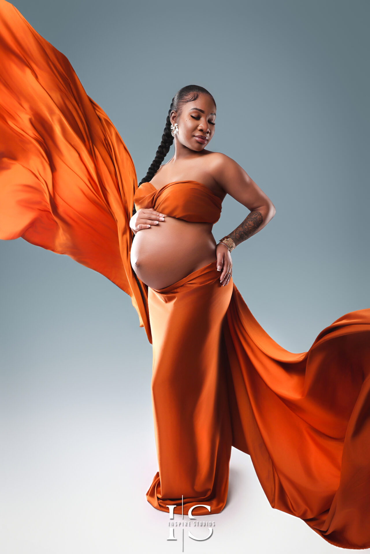 Dramatic flying dress maternity photoshoot in London, showcasing an expecting mother in a flowing gown.