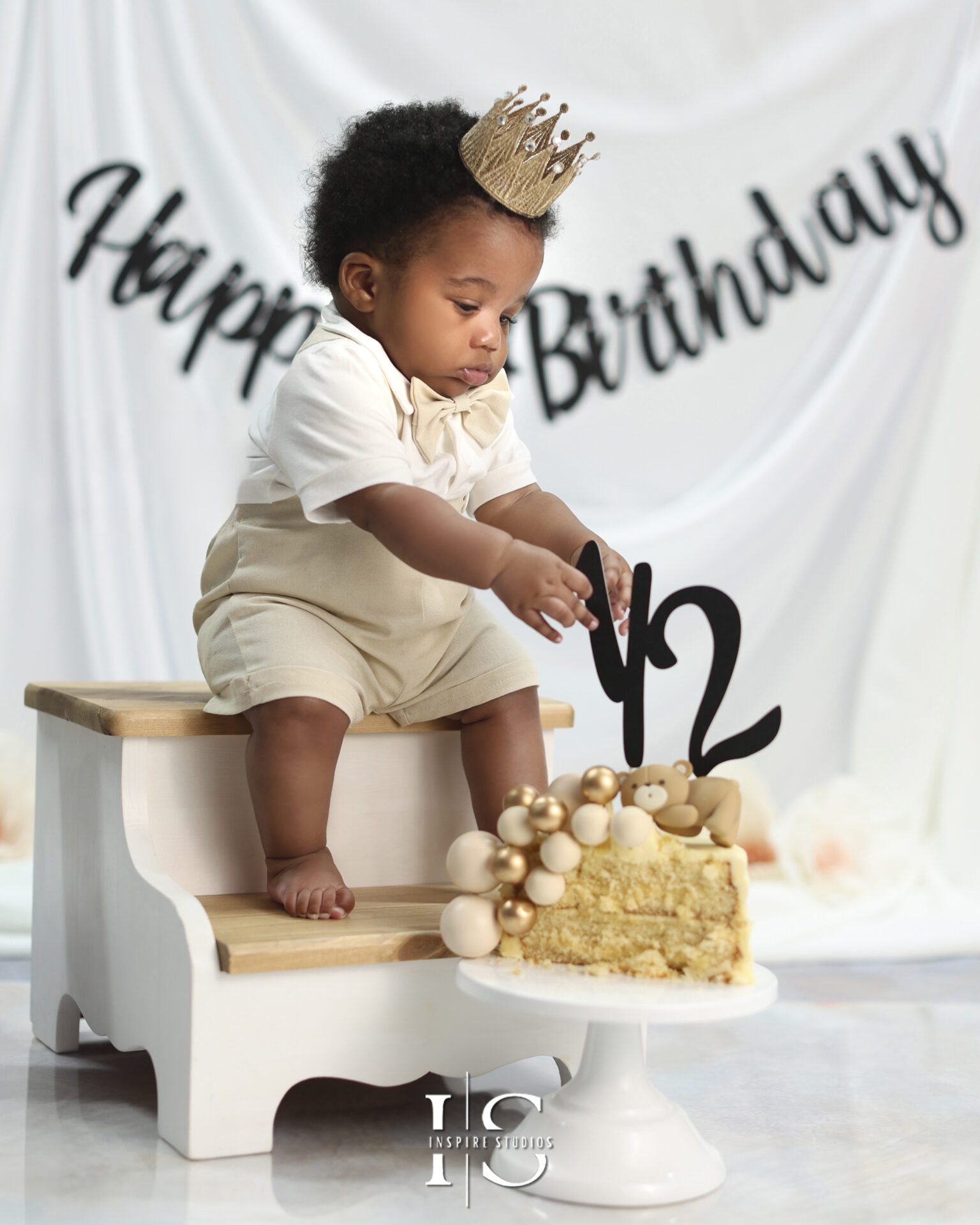 Six-month-old baby posing with a birthday crown in a half-year birthday photoshoot.