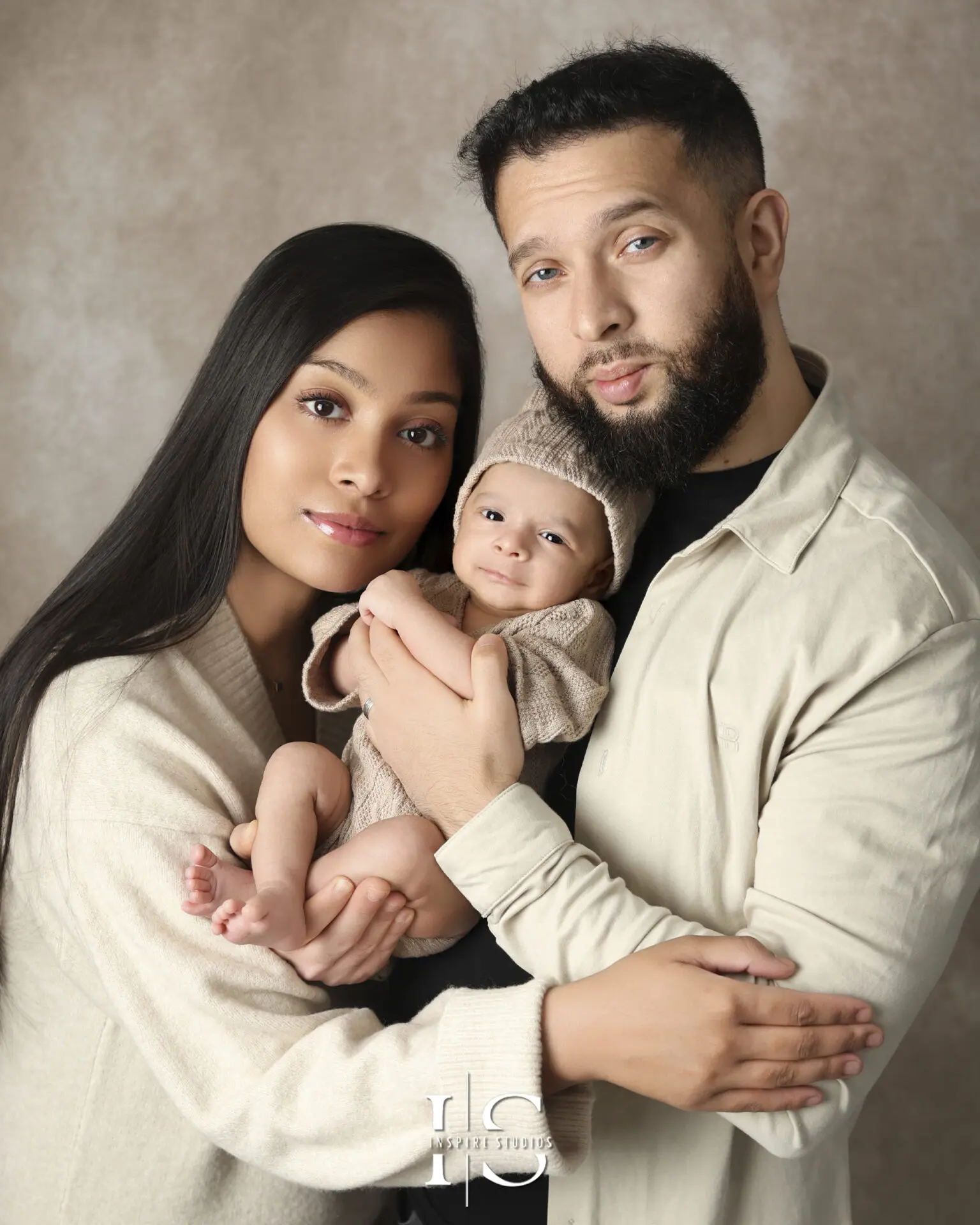 A peaceful newborn sleeping in a beautifully arranged family photoshoot setting inside a London studio.