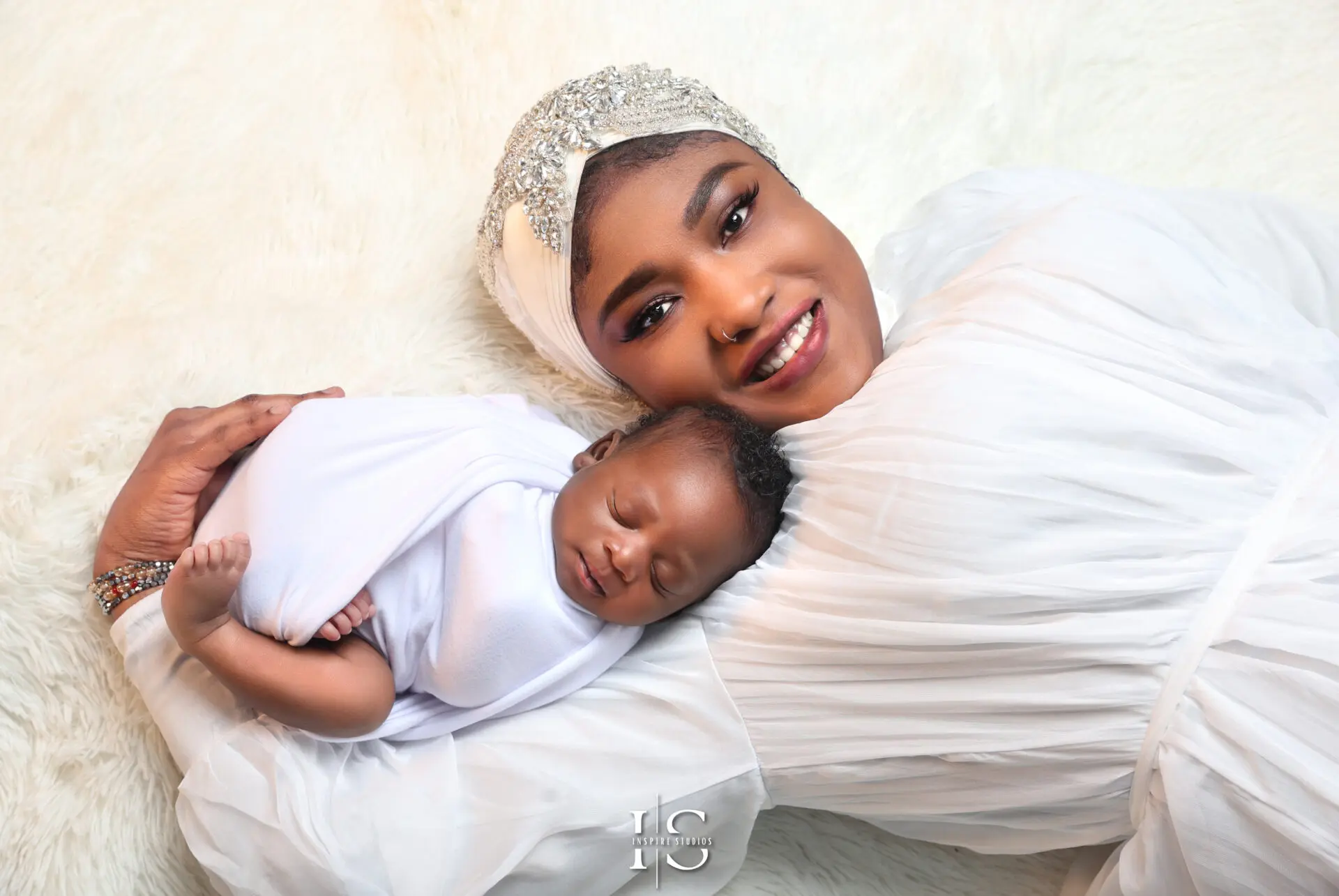 A loving family posing with their newborn baby in a cozy Walthamstow studio.