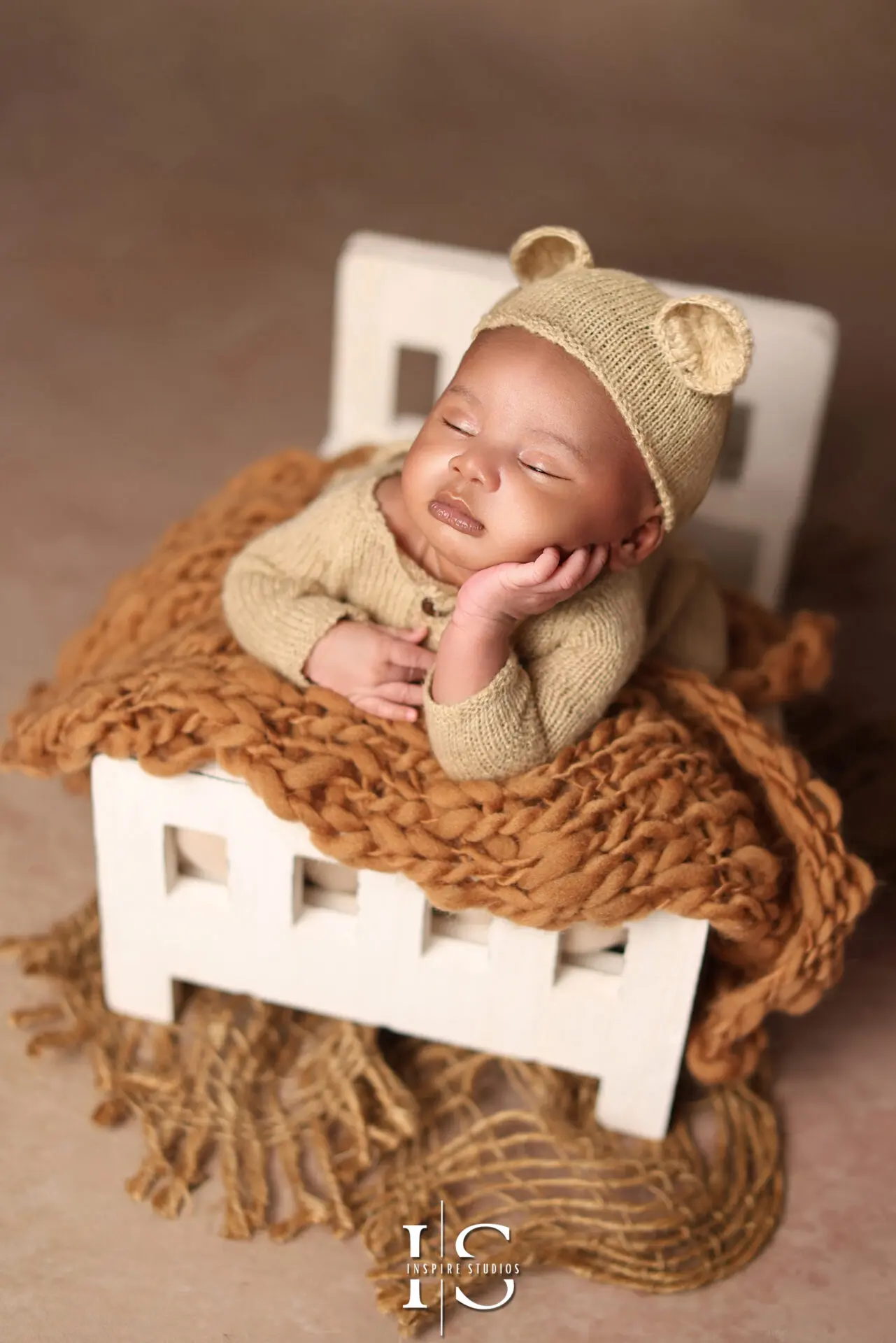 A sleeping newborn in a delicate, professional photoshoot setup with an affordable photography package.