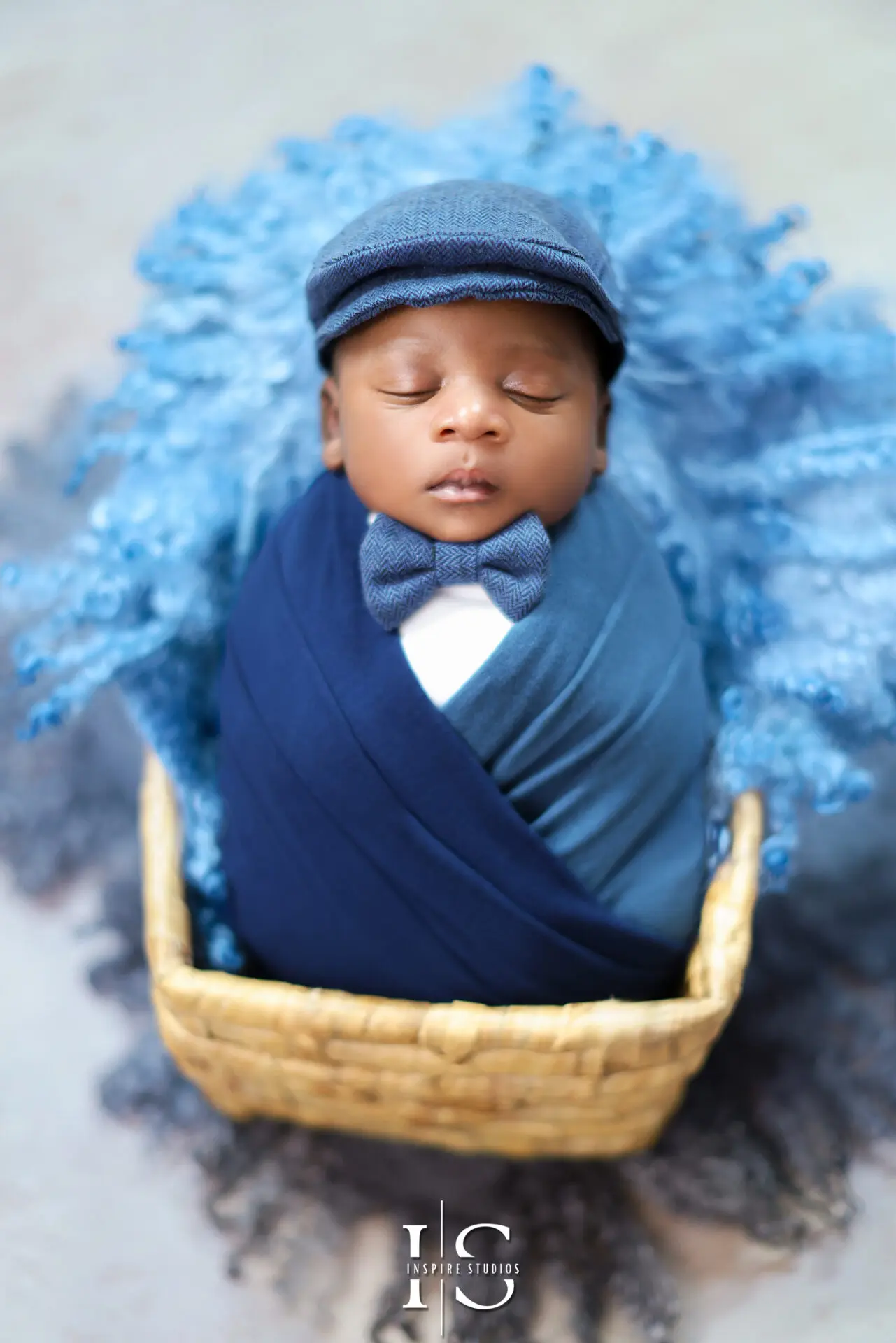 Newborn baby girl in a cozy pose with soft pastel tones.