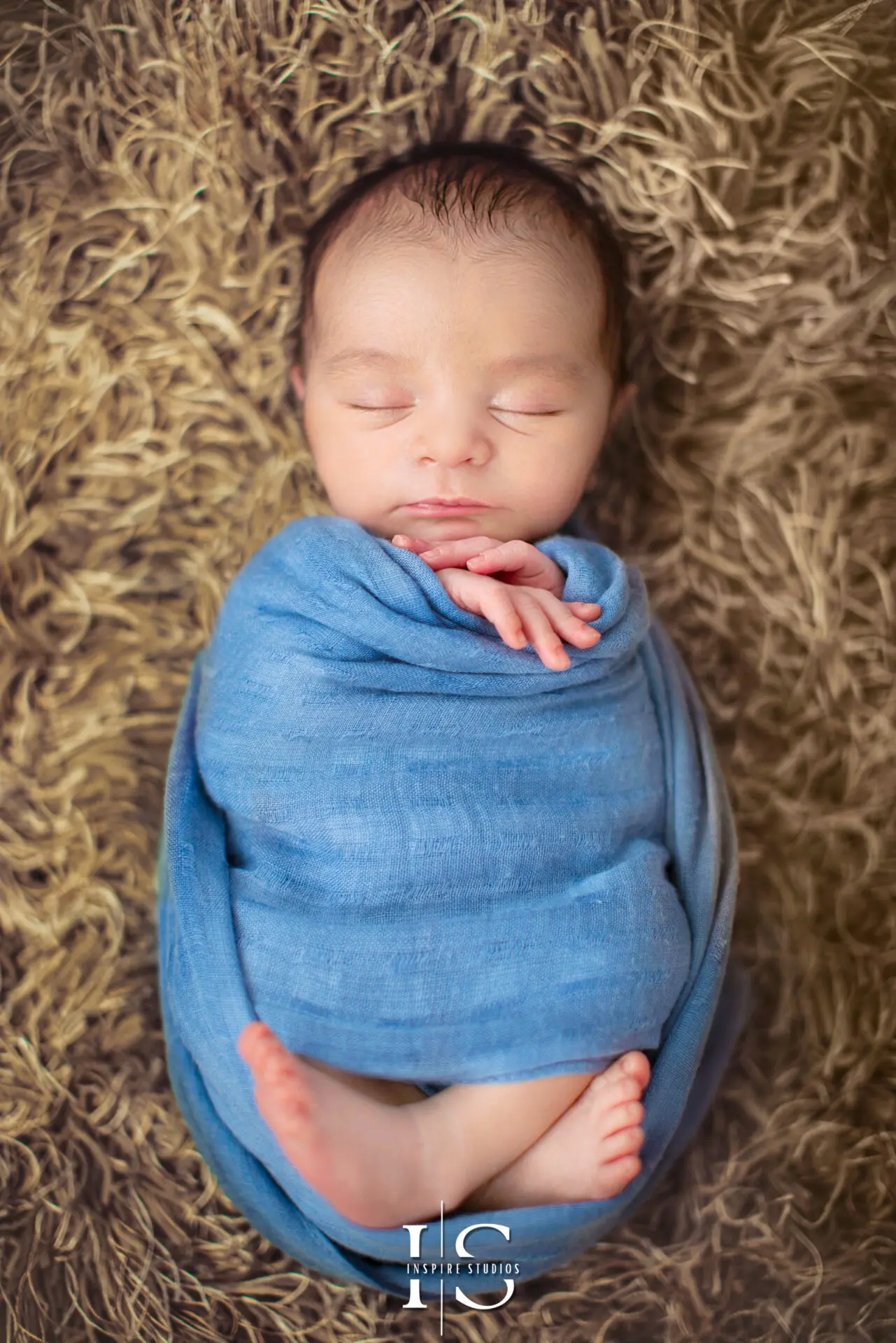 One-week-old newborn baby sleeping peacefully in a basket.