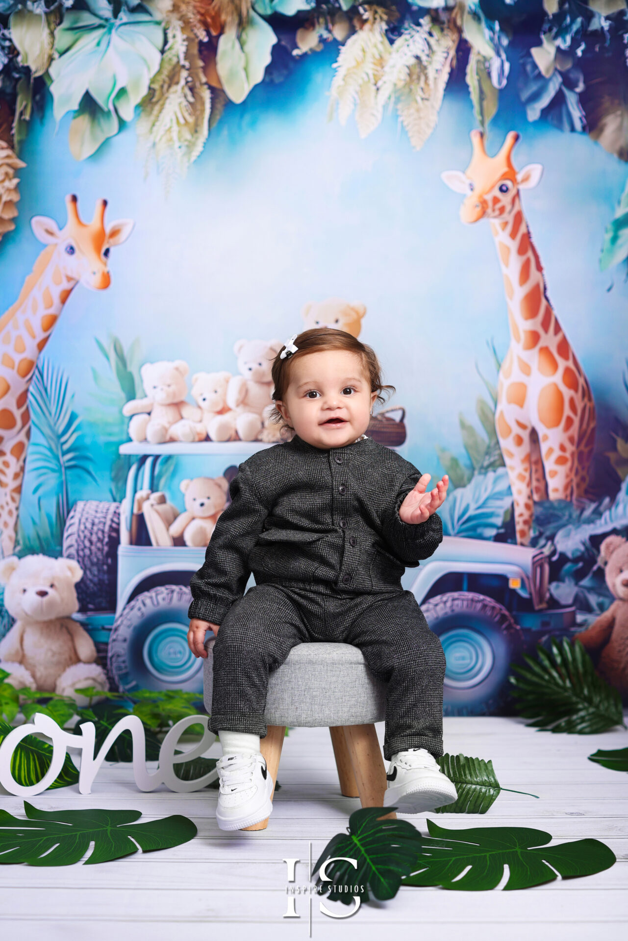 London first birthday photography session with "Wild & One" theme, showcasing a smiling toddler and jungle-themed decor.