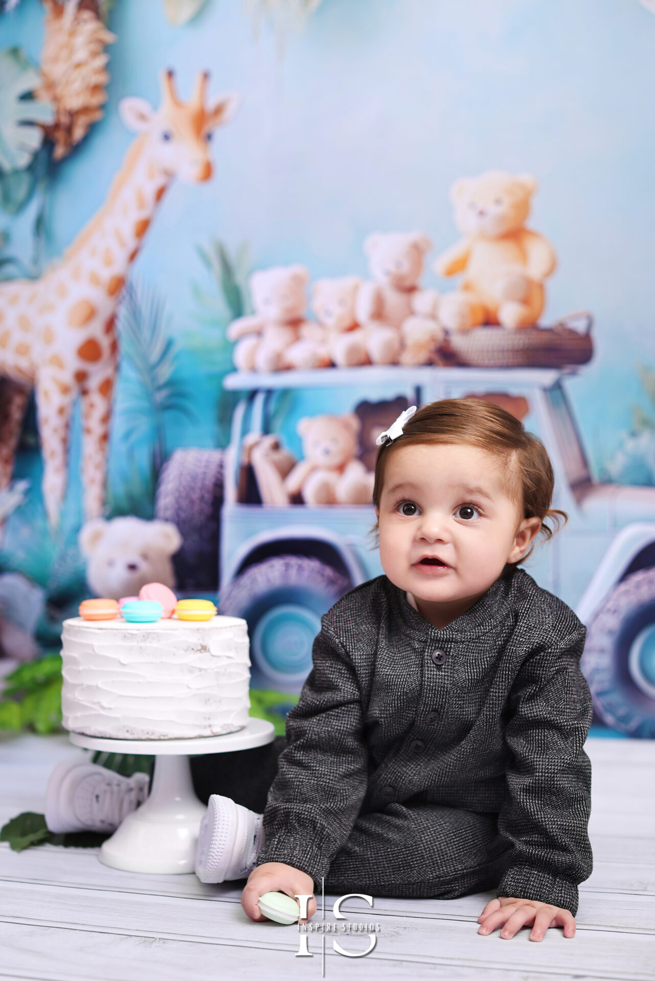 Adorable "Wild & One" first birthday photoshoot in London featuring a jungle-themed cake smash and playful decorations.