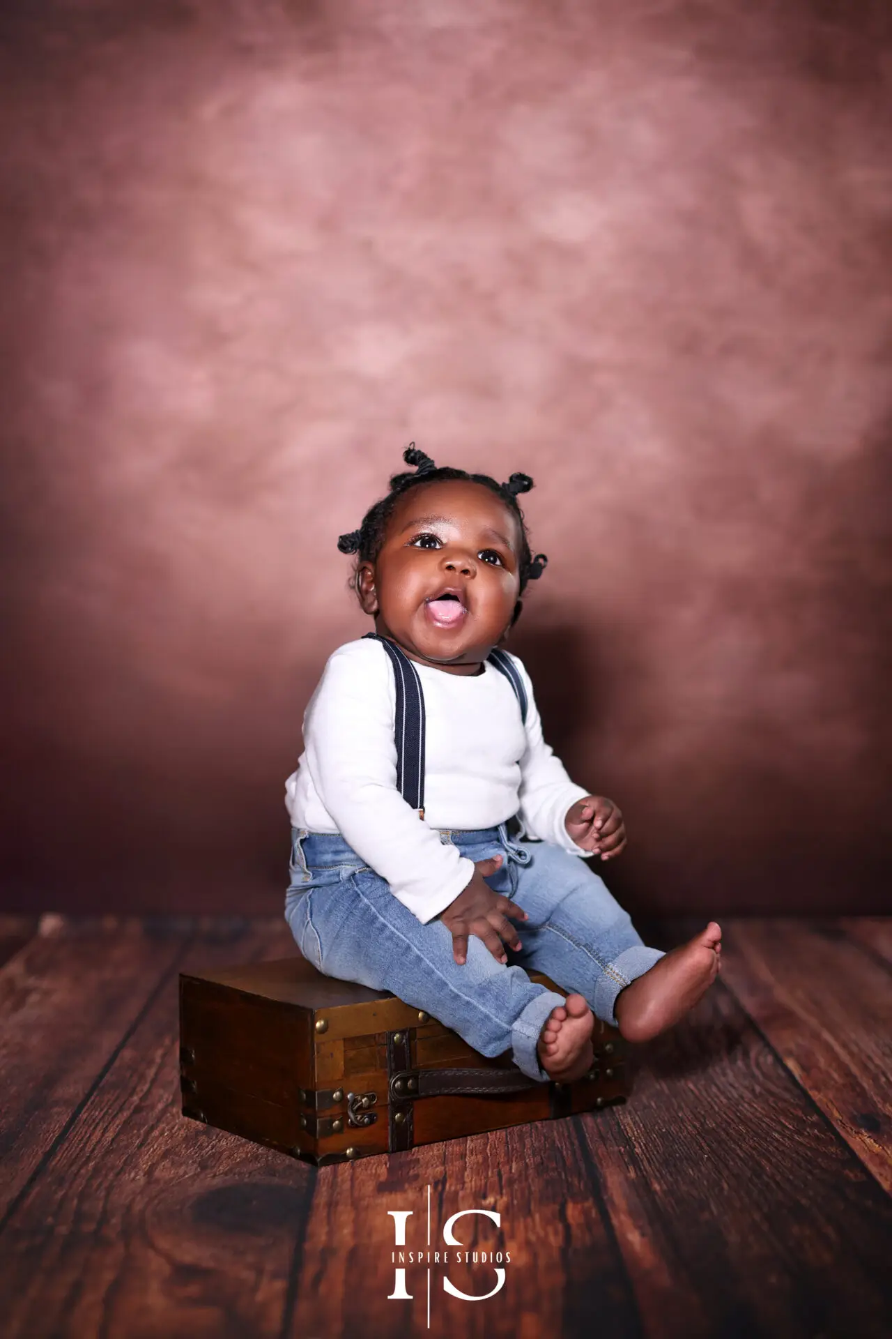 Baby and parents posing together in a professional studio setup