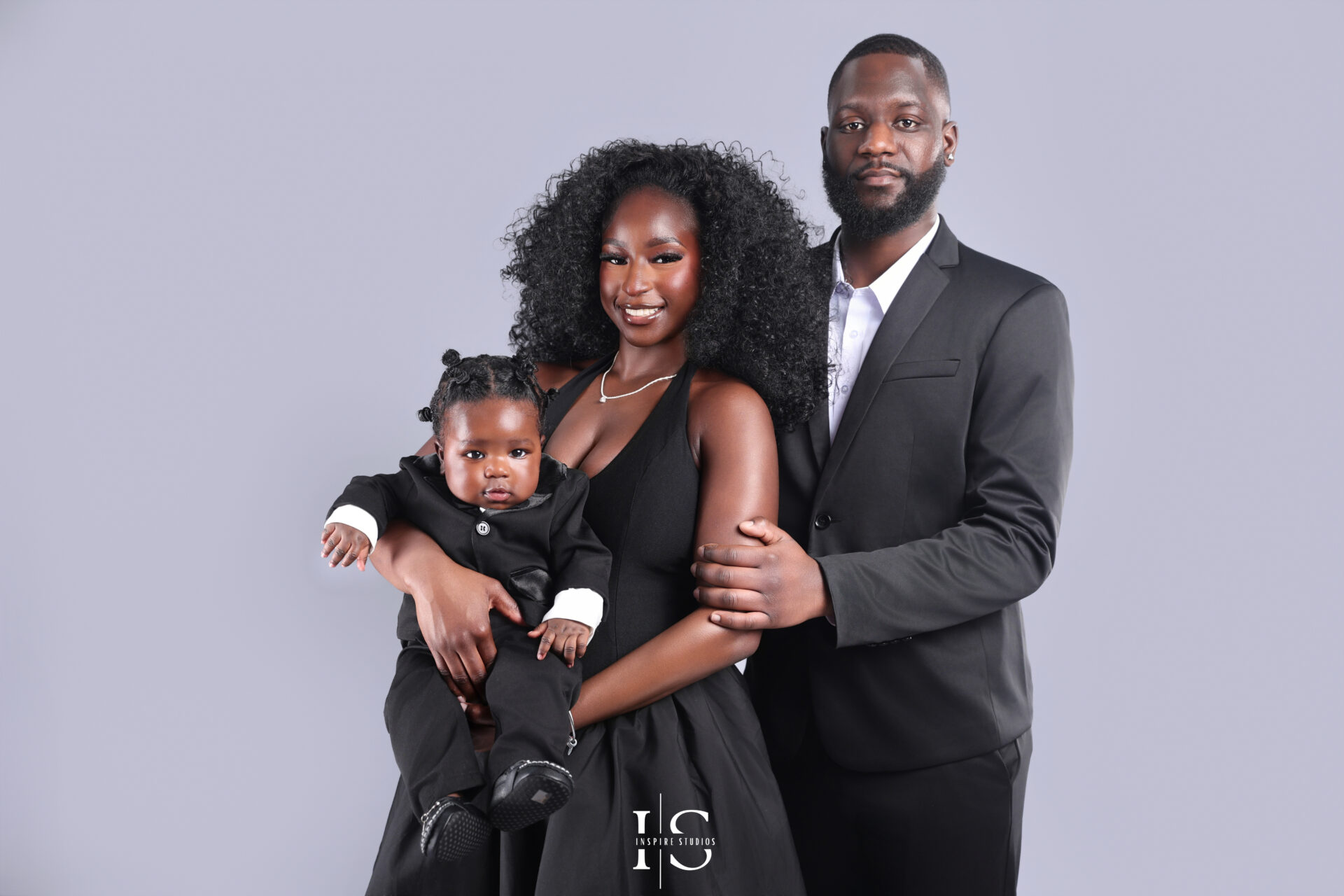 Family smiling together during a studio photo session in London