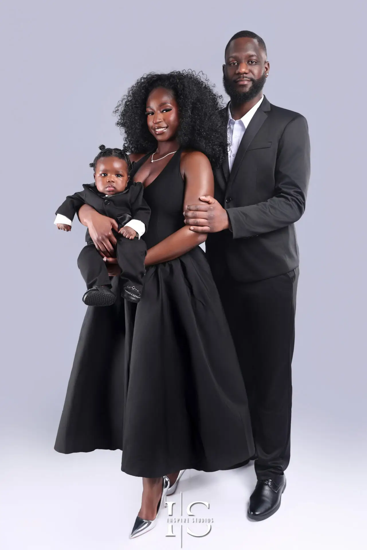 Professional family portrait with baby in a cozy indoor studio