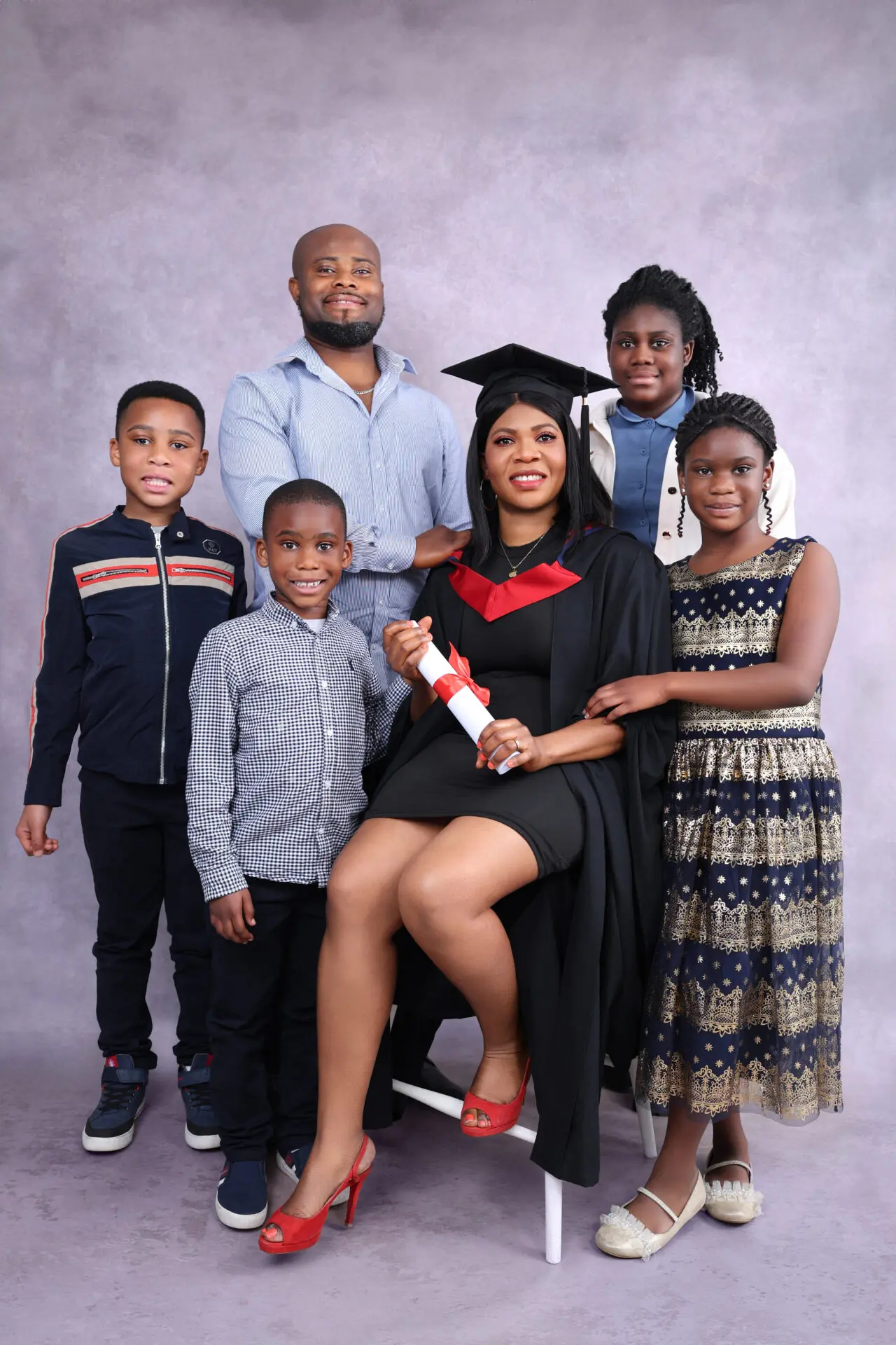 Studio portrait of graduate and family during photoshoot in London
