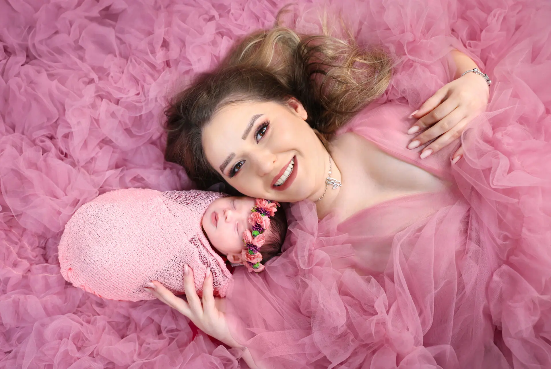 Newborn snuggling with mom during a professional London studio photo session.