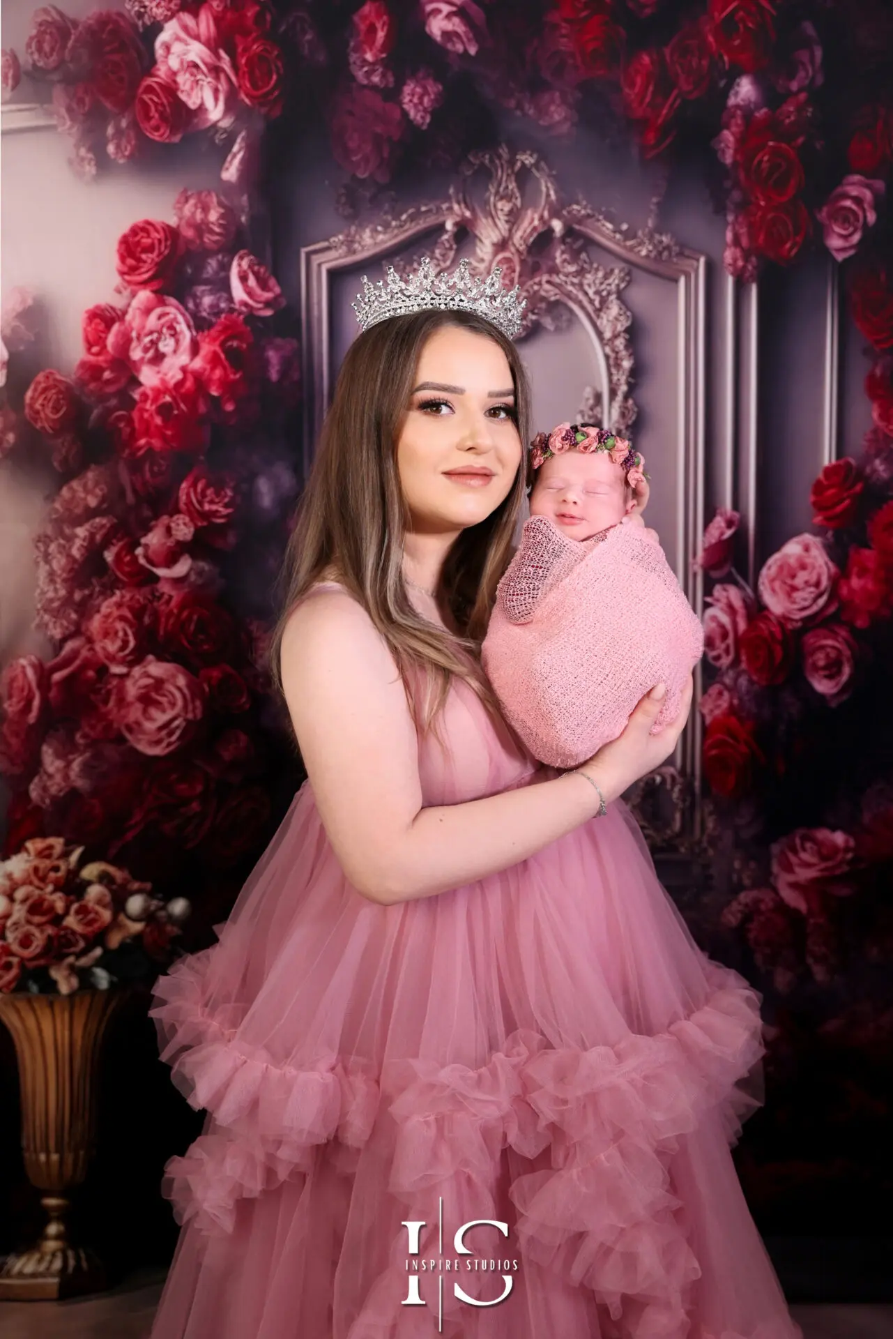 Mother holding newborn baby during studio photoshoot in London.