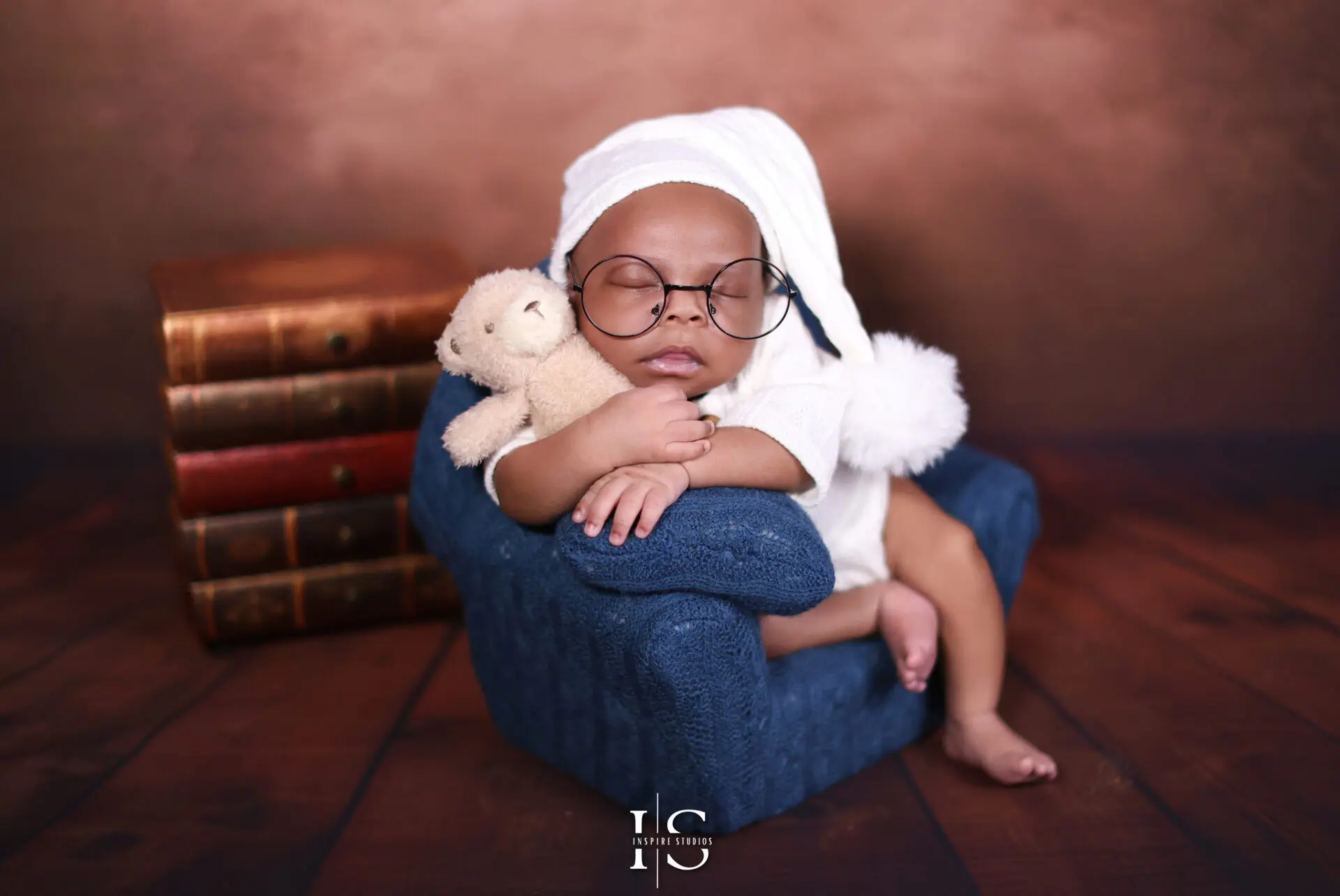 Newborn baby during a professional photoshoot in a London studio, wrapped and peacefully sleeping.