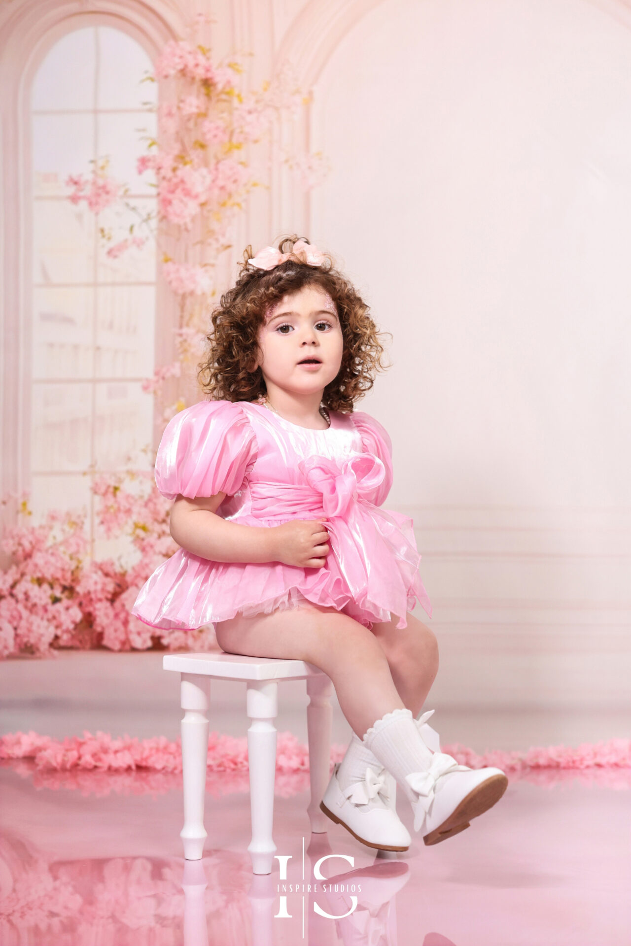 Two-year-old girl enjoying a custom-styled birthday photoshoot.