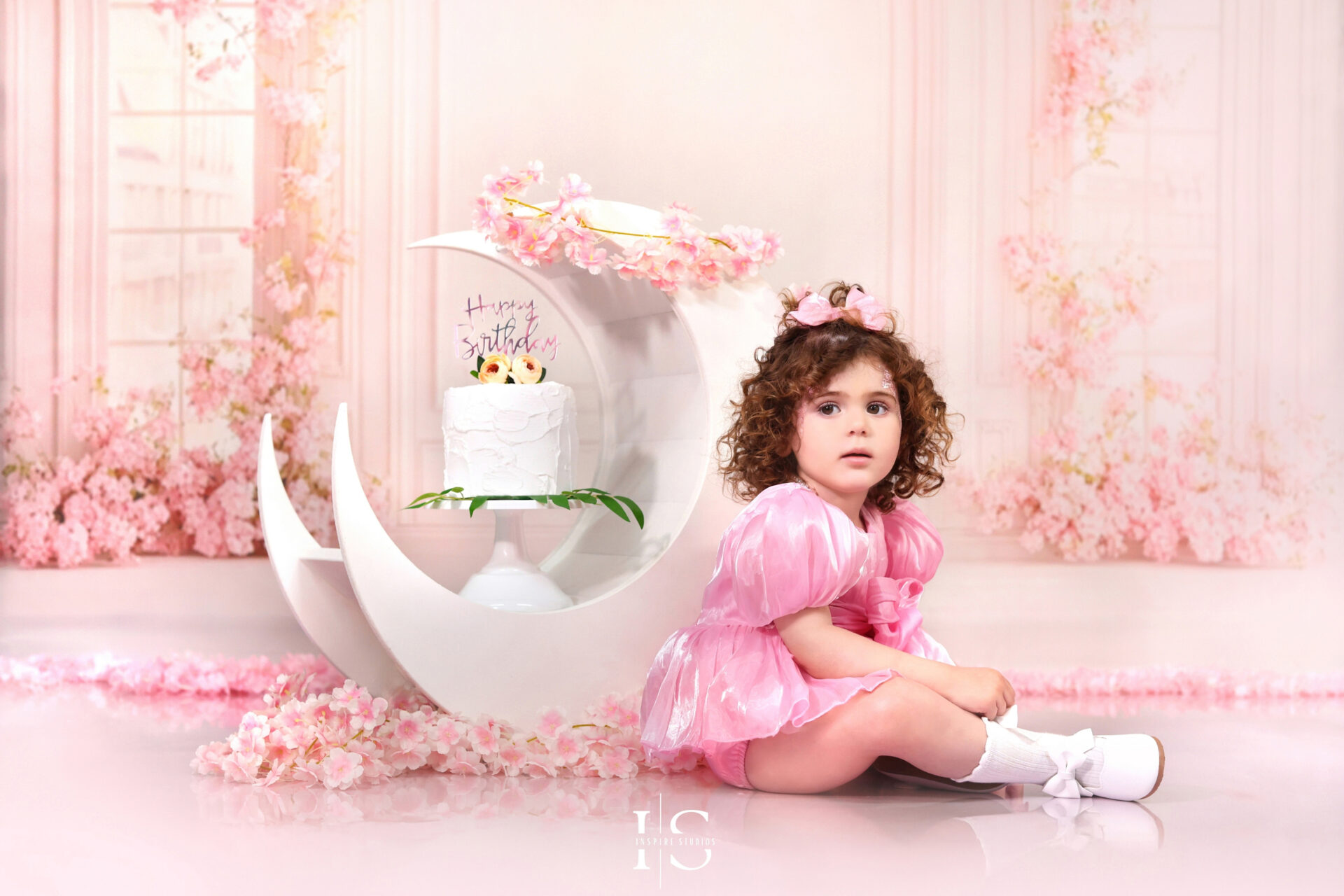 Styled studio portrait for a toddler's second birthday celebration.