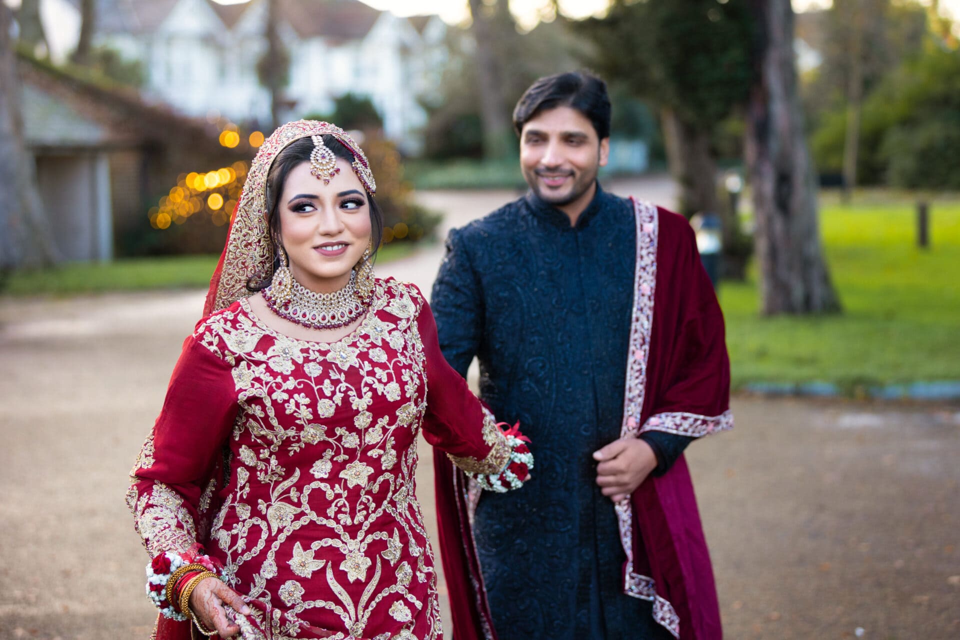 Bride and groom posing together in a romantic park setting
