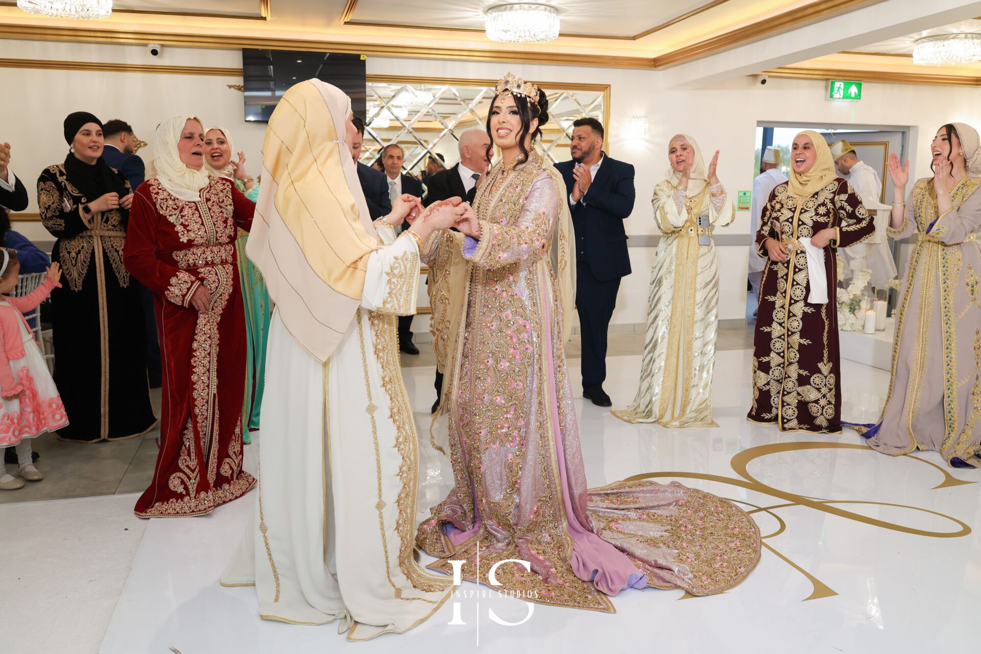 Bride and groom under floral arch in Moroccan wedding