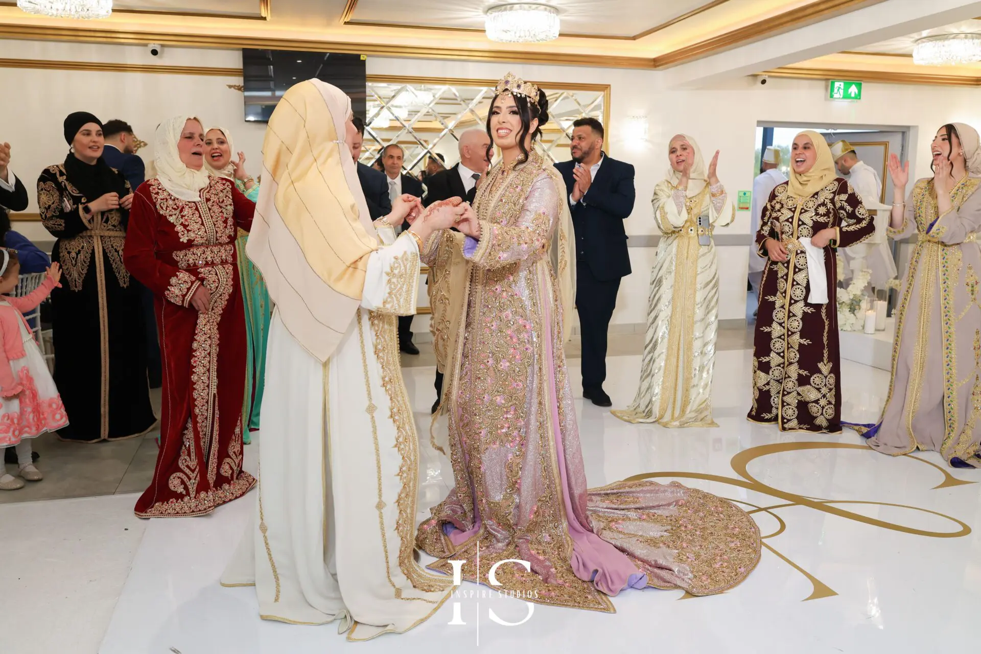 Bride and groom under floral arch in Moroccan wedding