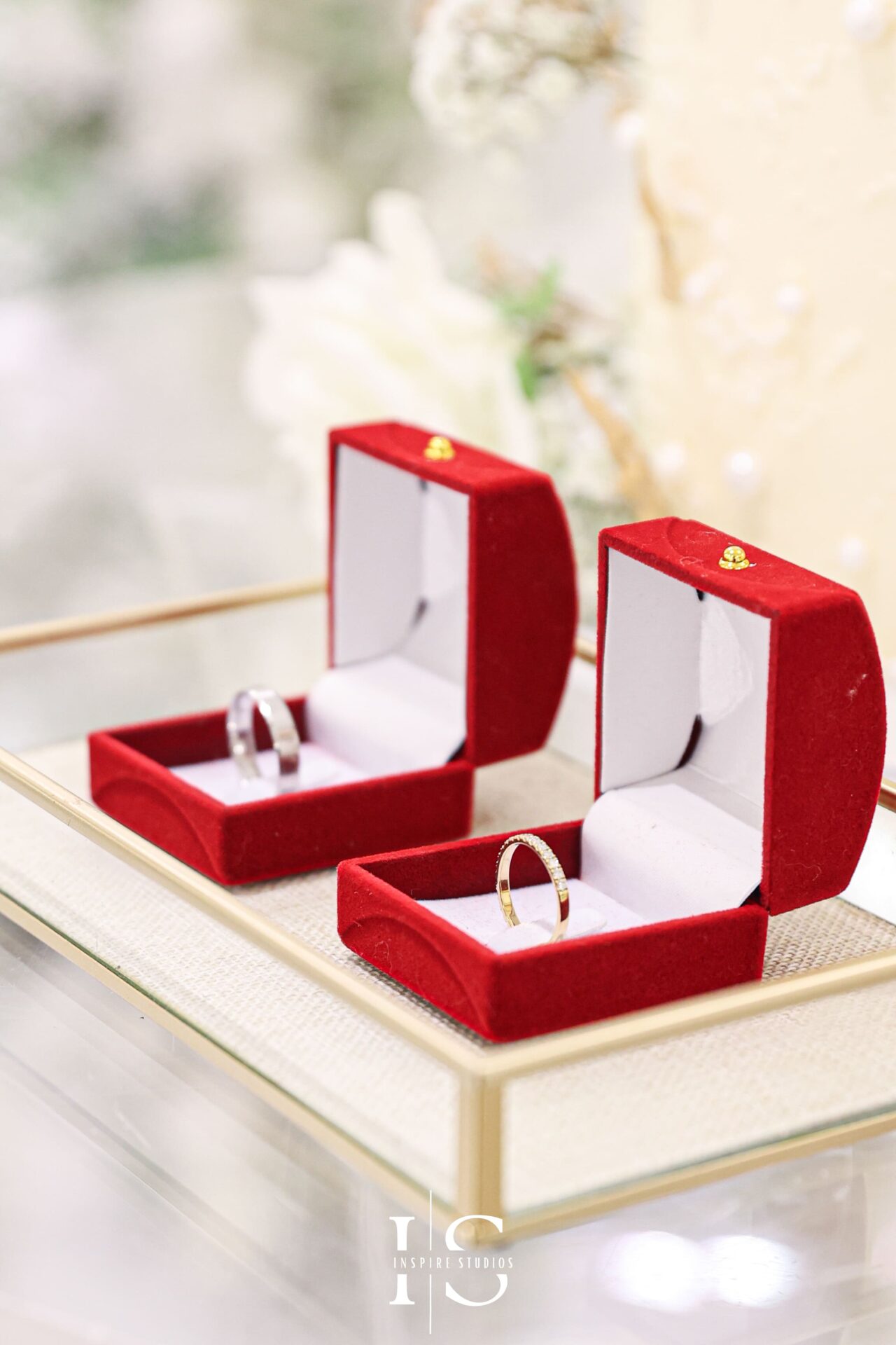Moroccan wedding rings placed beside a traditional wedding cake