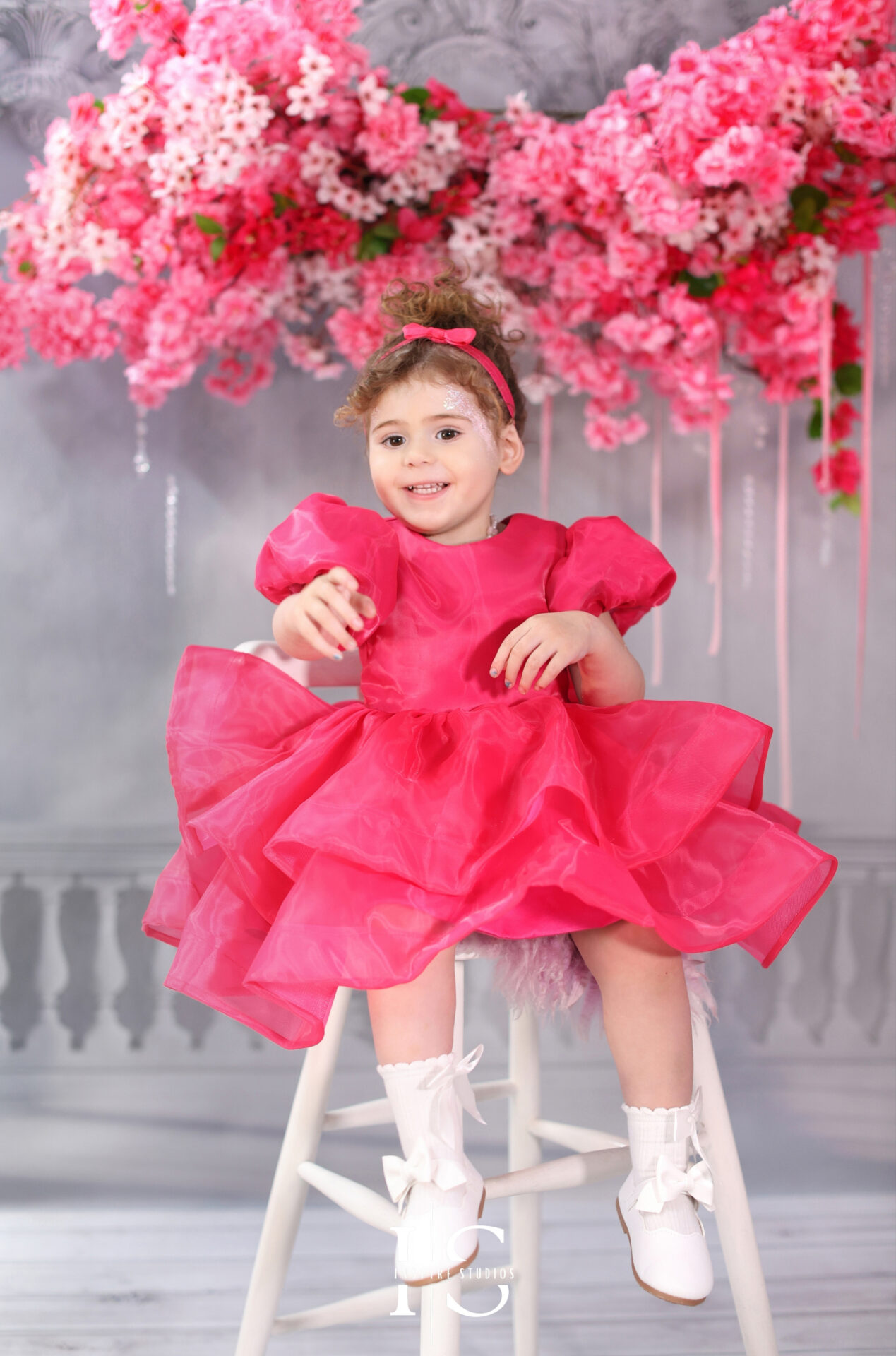 Toddler girl posing during her second birthday studio photoshoot.