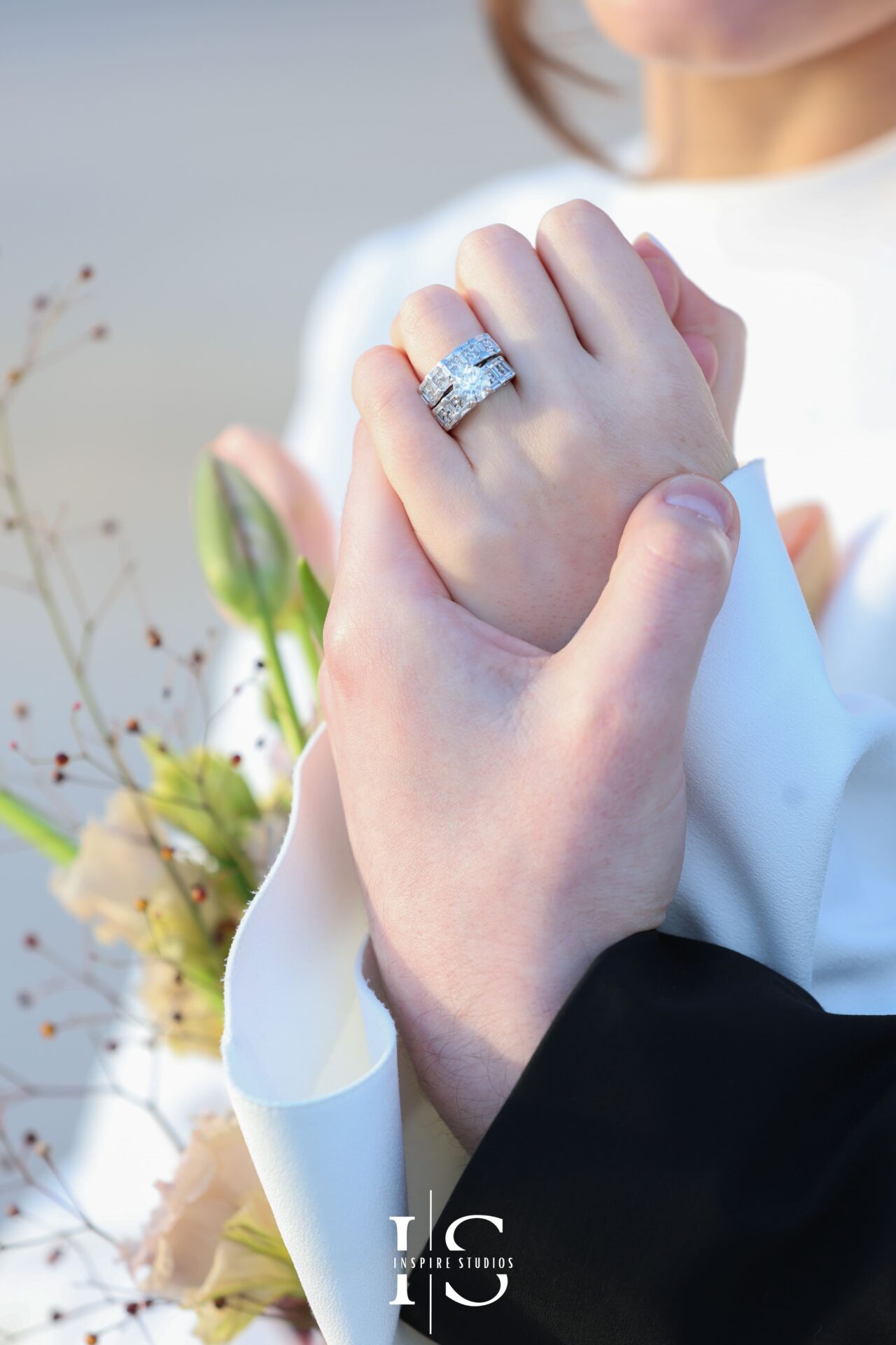 Close-up of intertwined hands showing wedding rings after London registry ceremony