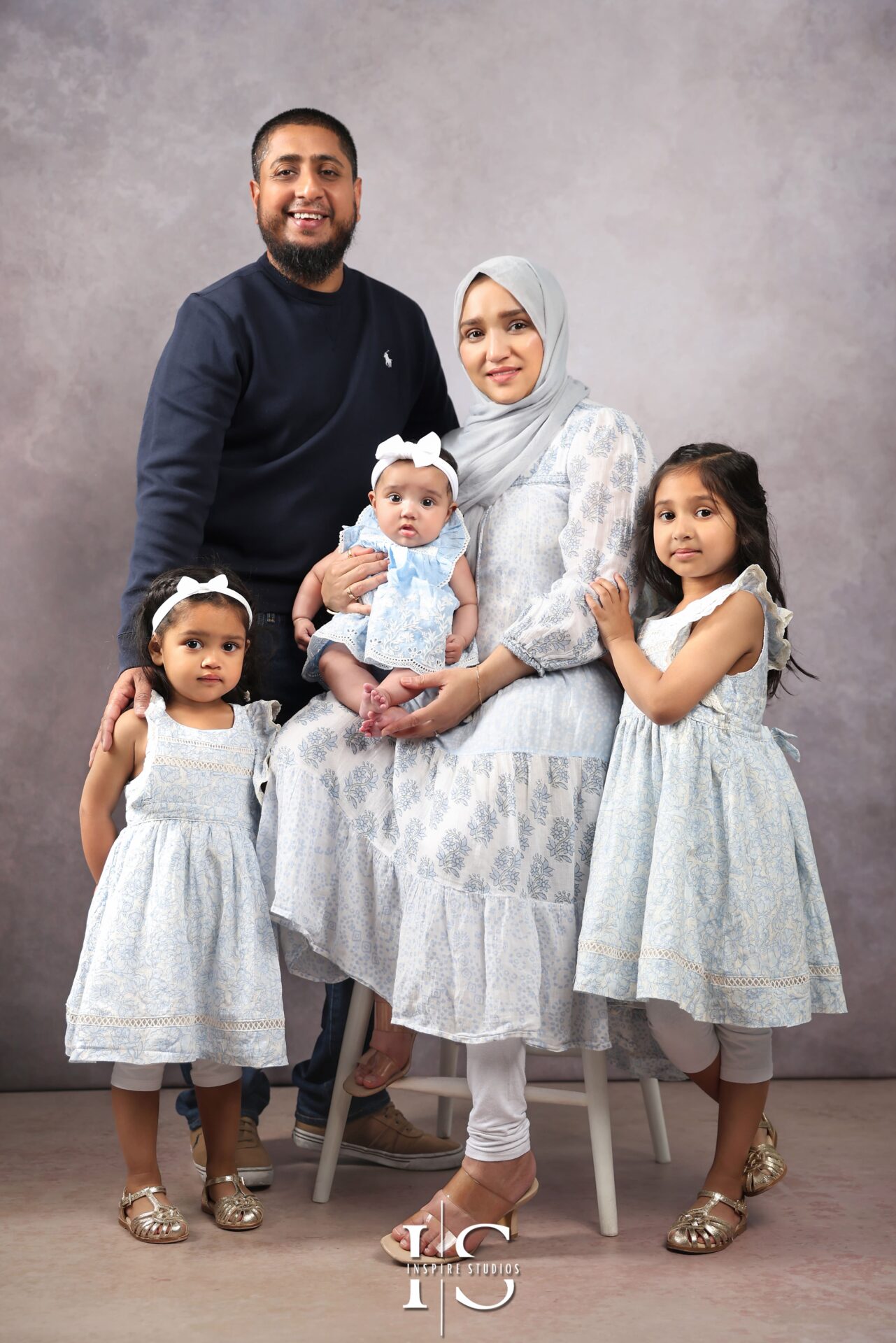 Smiling family posing together during a professional studio session in London.