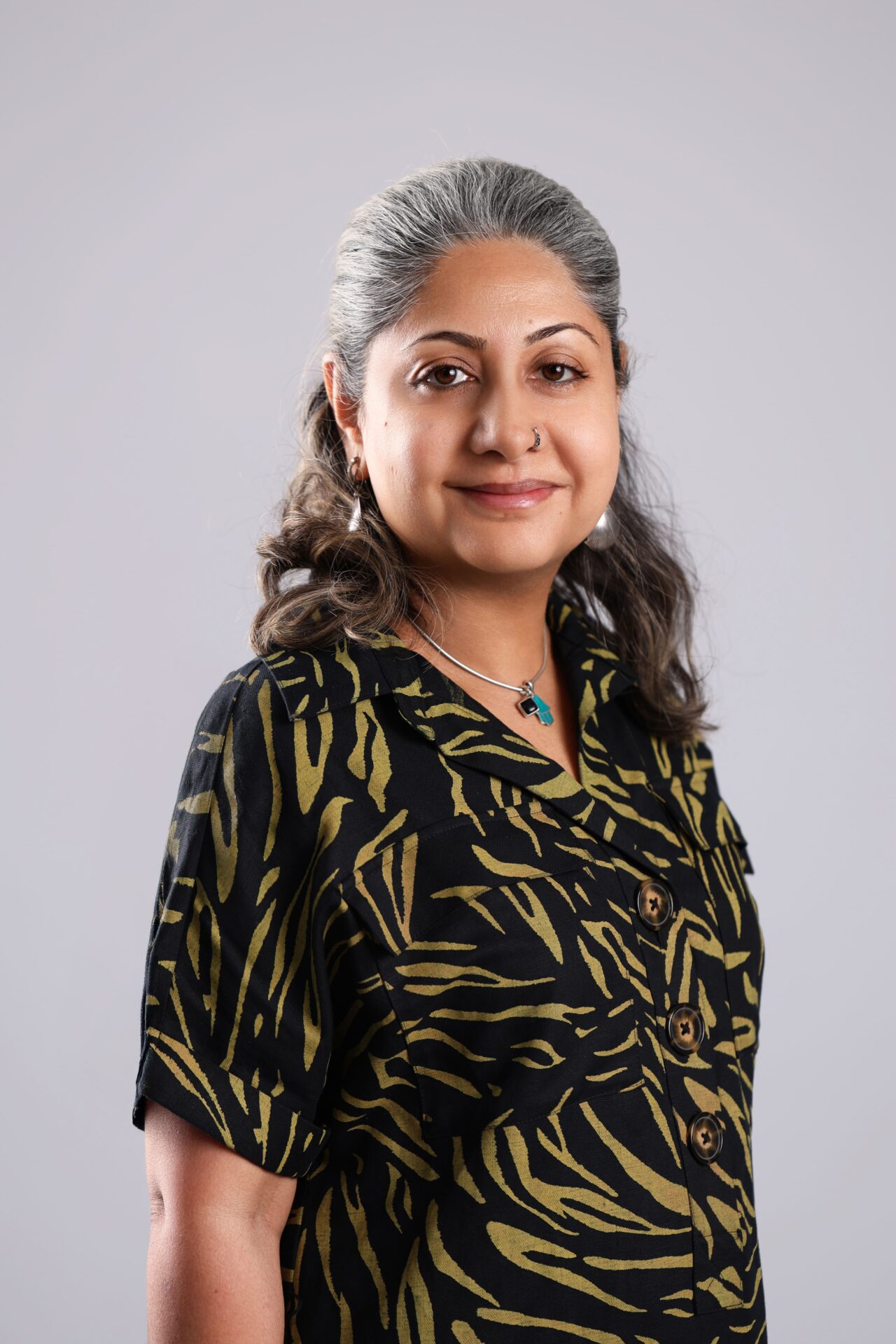 Professional woman posing for a LinkedIn headshot with a clean studio background.