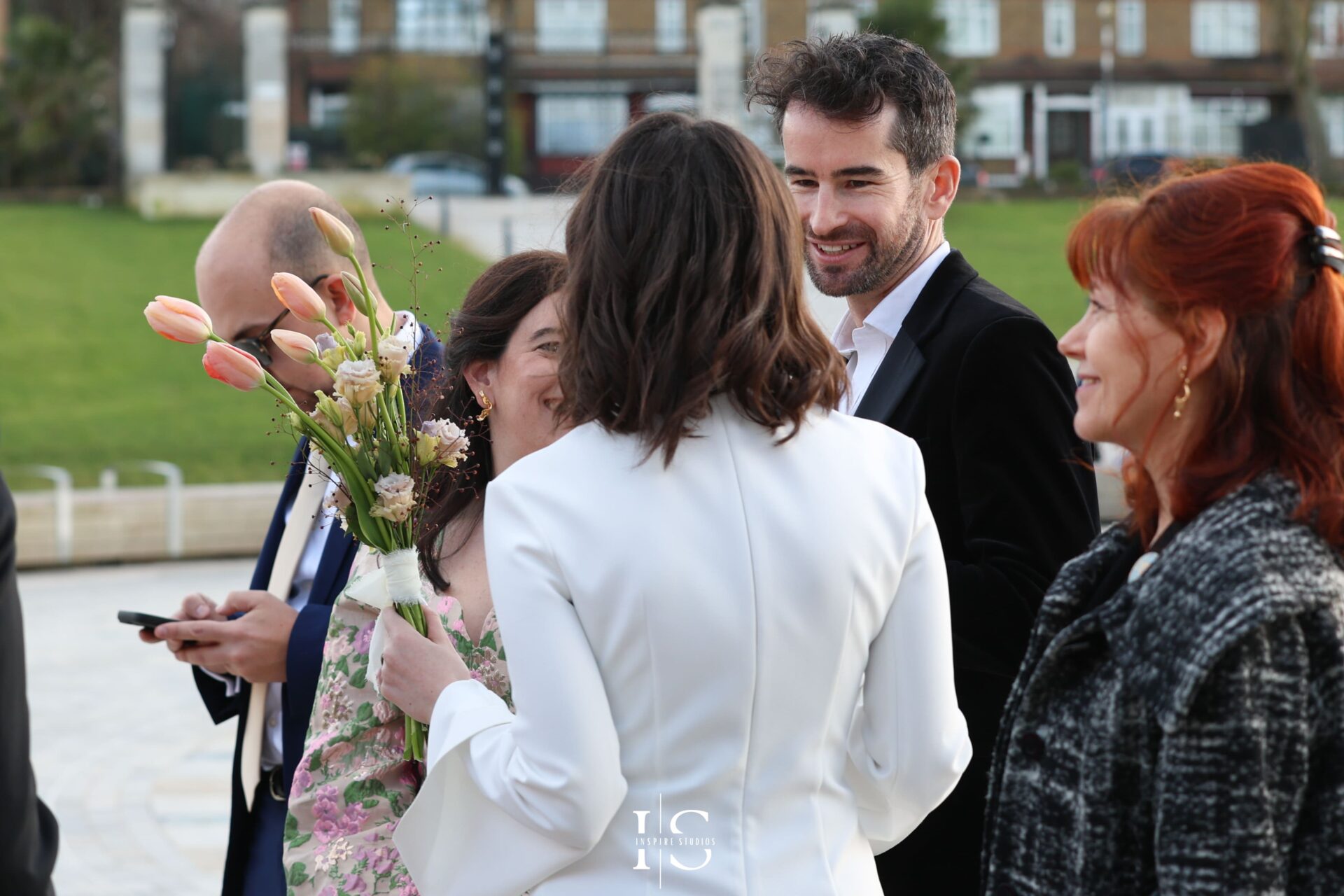Candid photo of guests greeting the couple after registry wedding at Walthamstow Town Hall