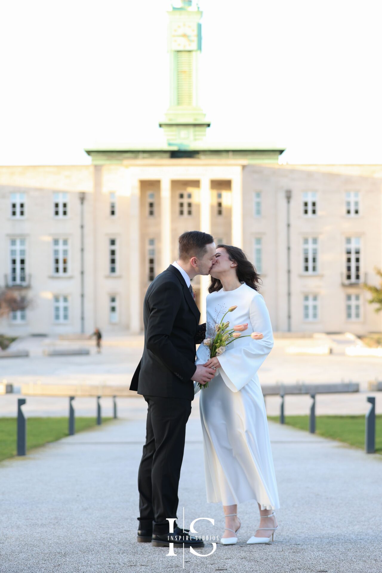 Bride and groom holding hands and smiling during photoshoot