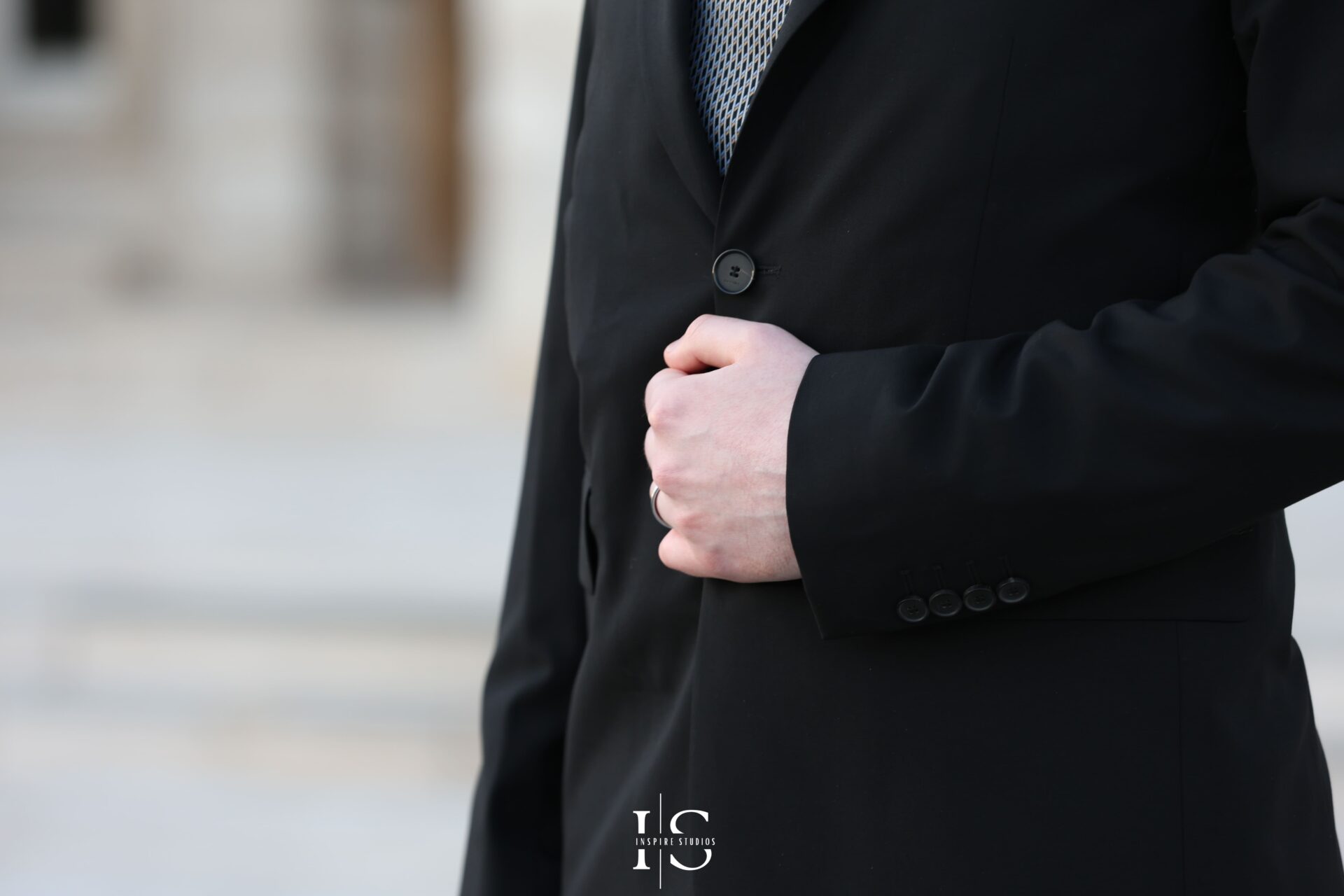 Close-up of groom’s accessories and hands before wedding ceremony