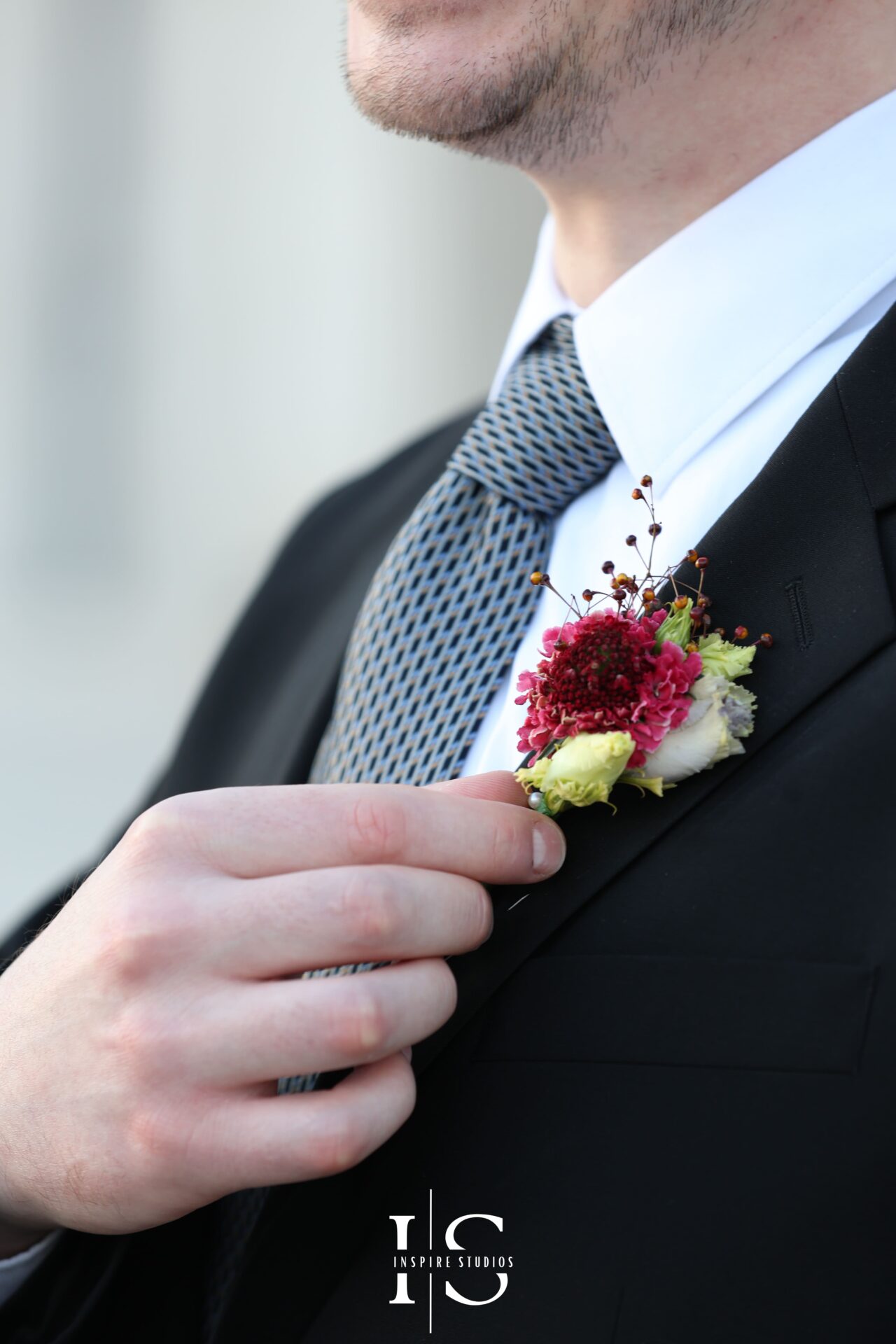 Groom adjusting watch and cufflinks before London registry wedding