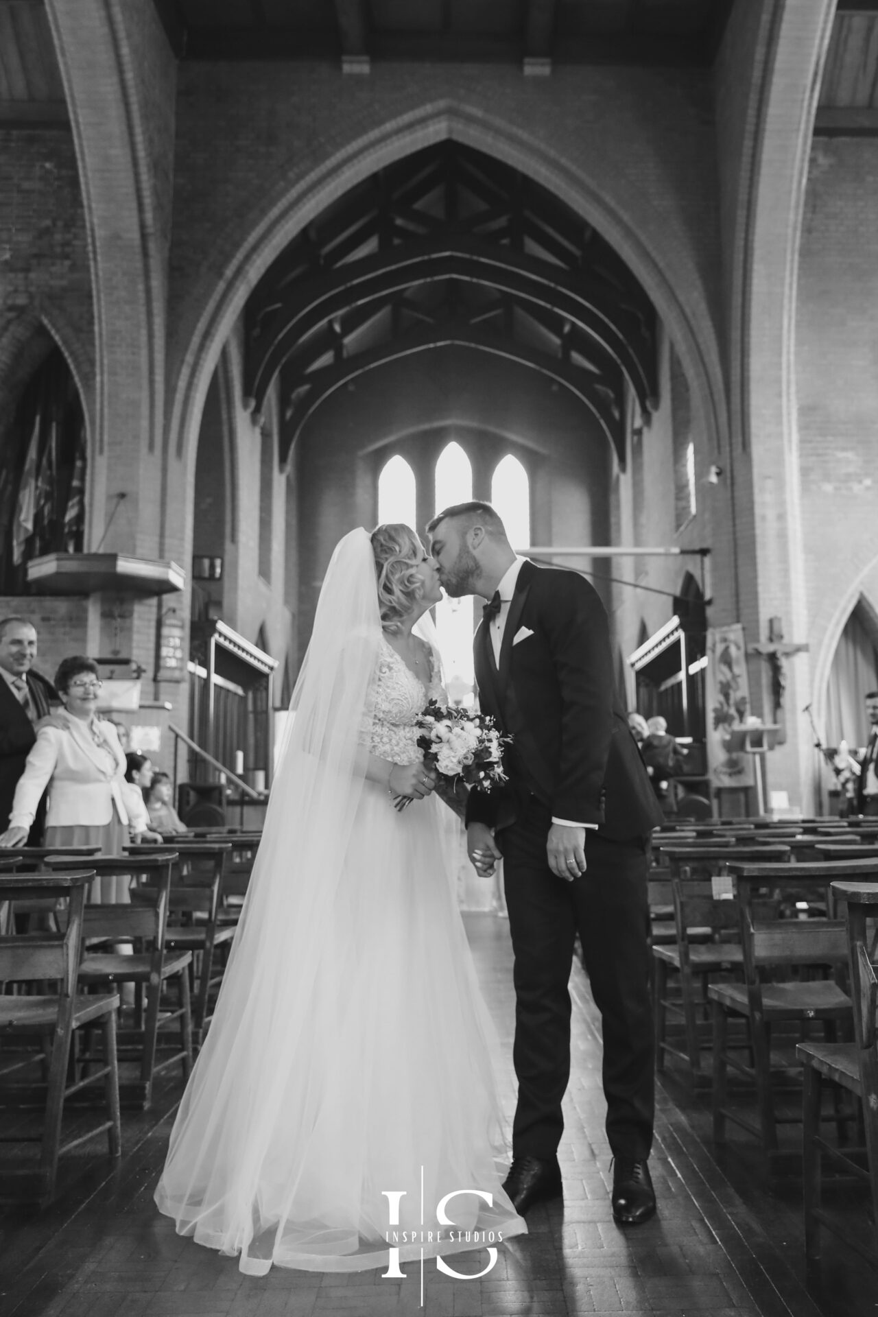 Bride and groom under arch captured naturally
