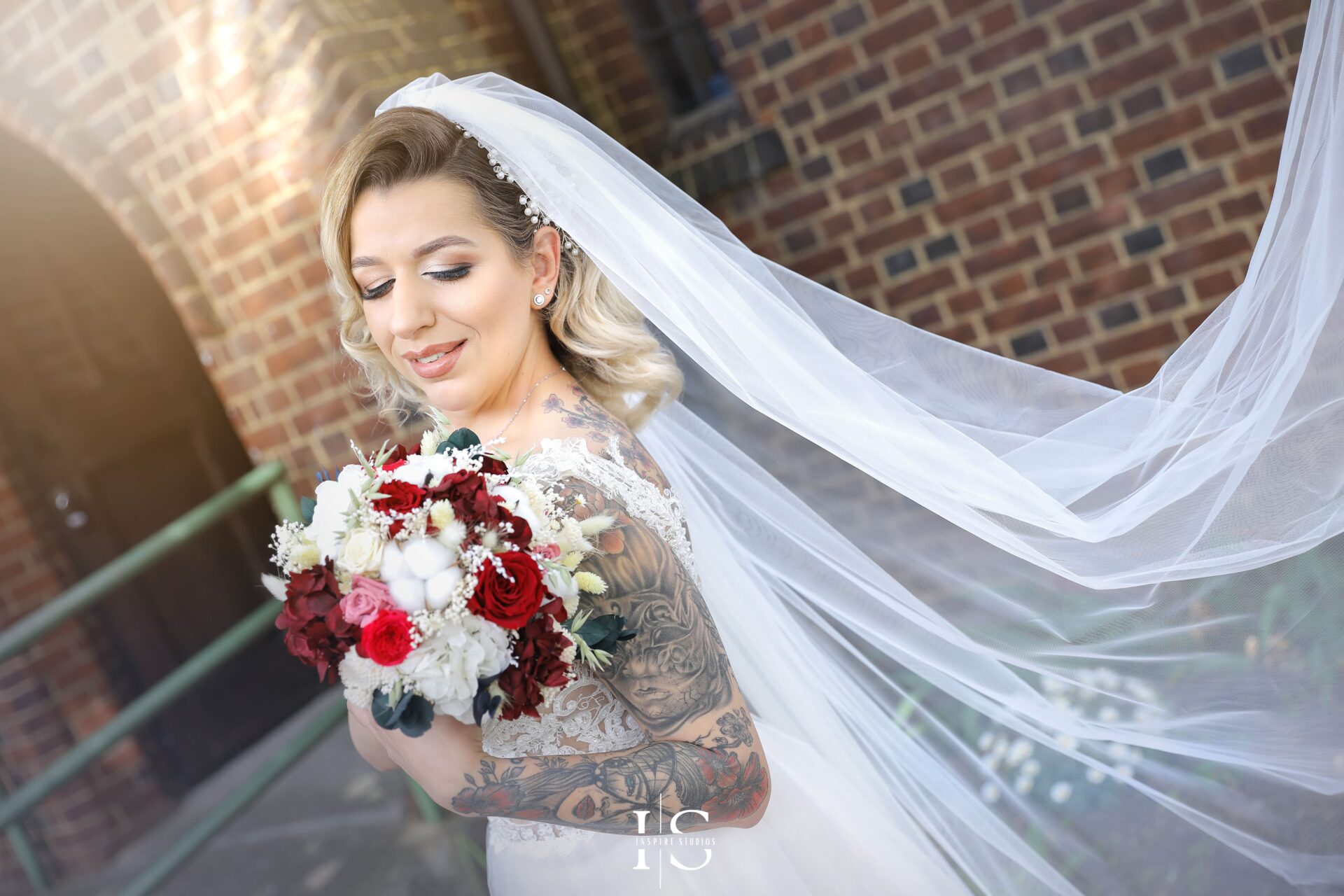 Couple kissing in wedding attire, photographed in London