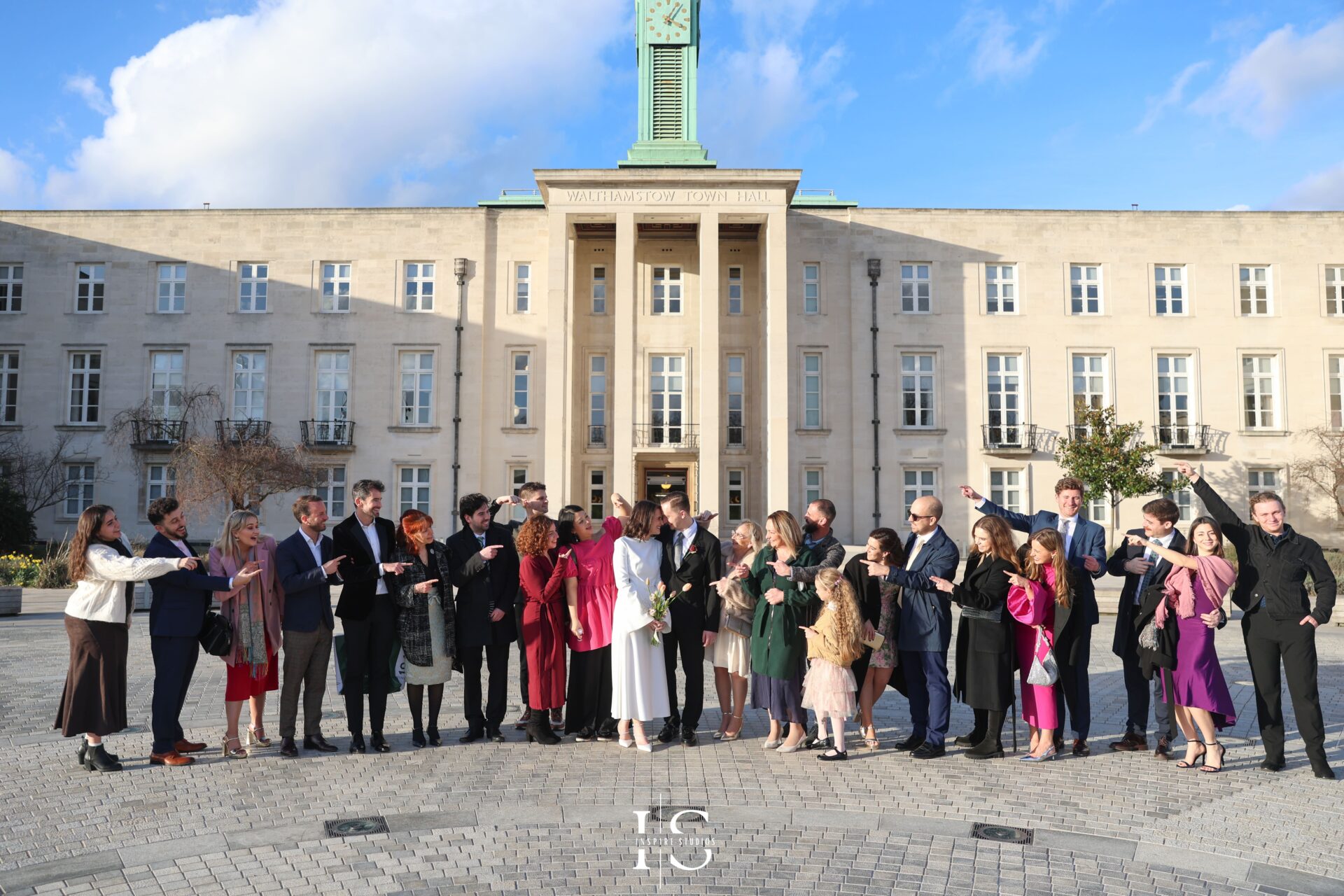 Group portrait with bride, groom, and guests outside Walthamstow Town Hall