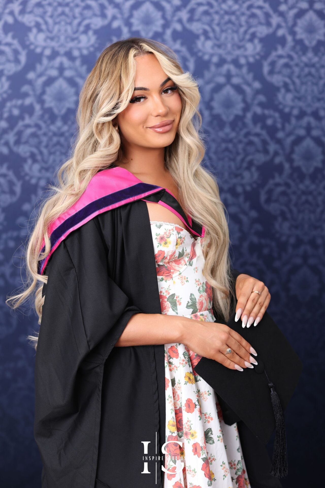 Graduation portrait with soft backdrop and warm tones in studio.