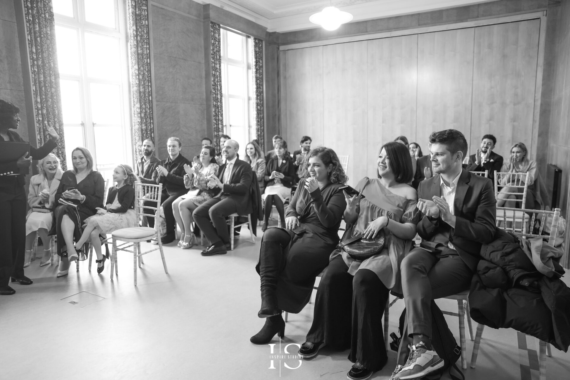 Guests clapping after the couple exchange rings