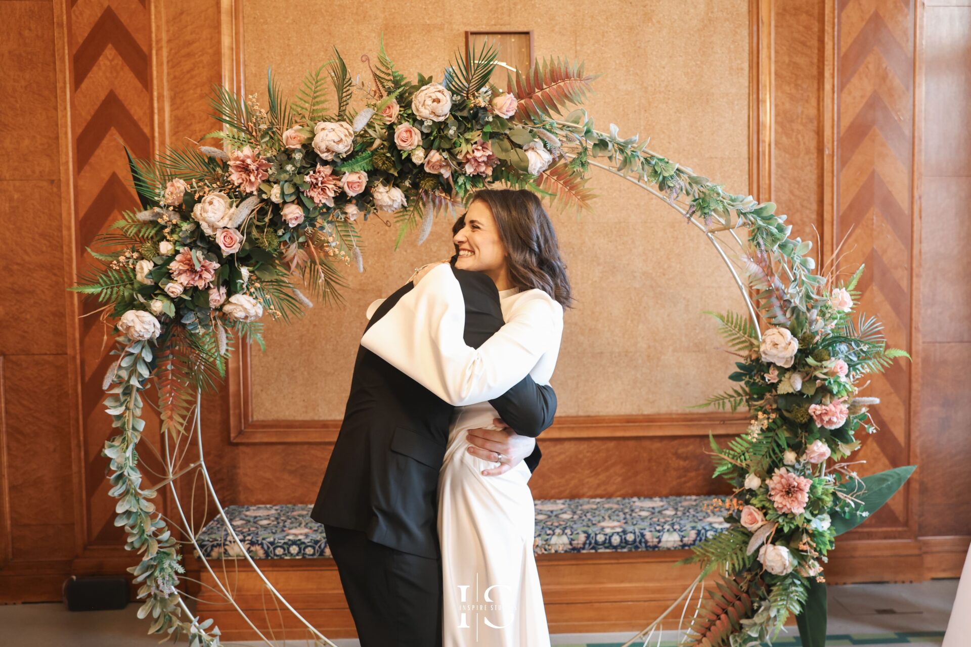 The couple holding hands during registry ceremony
