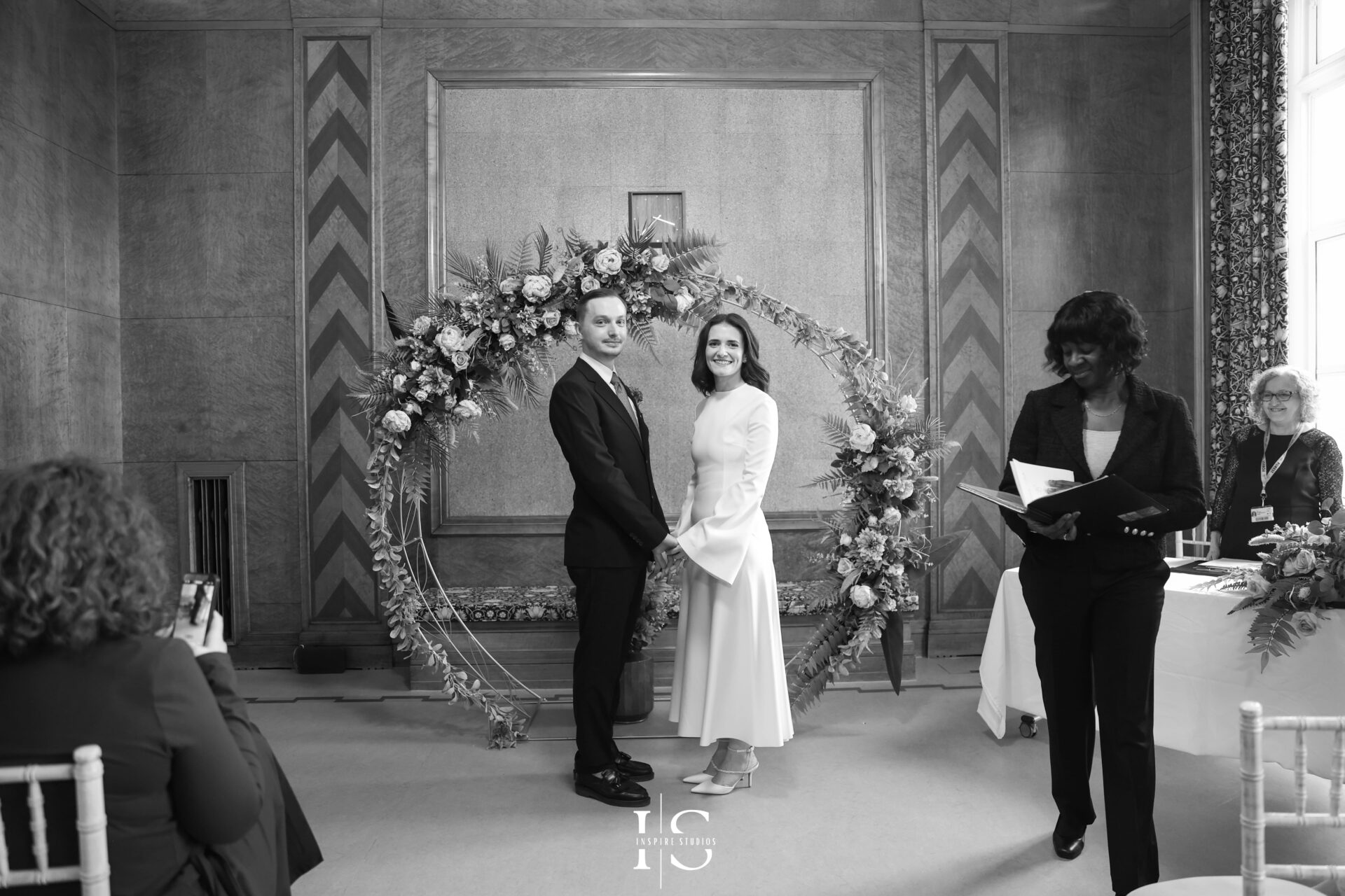 Bride and groom during vows at London registry ceremony