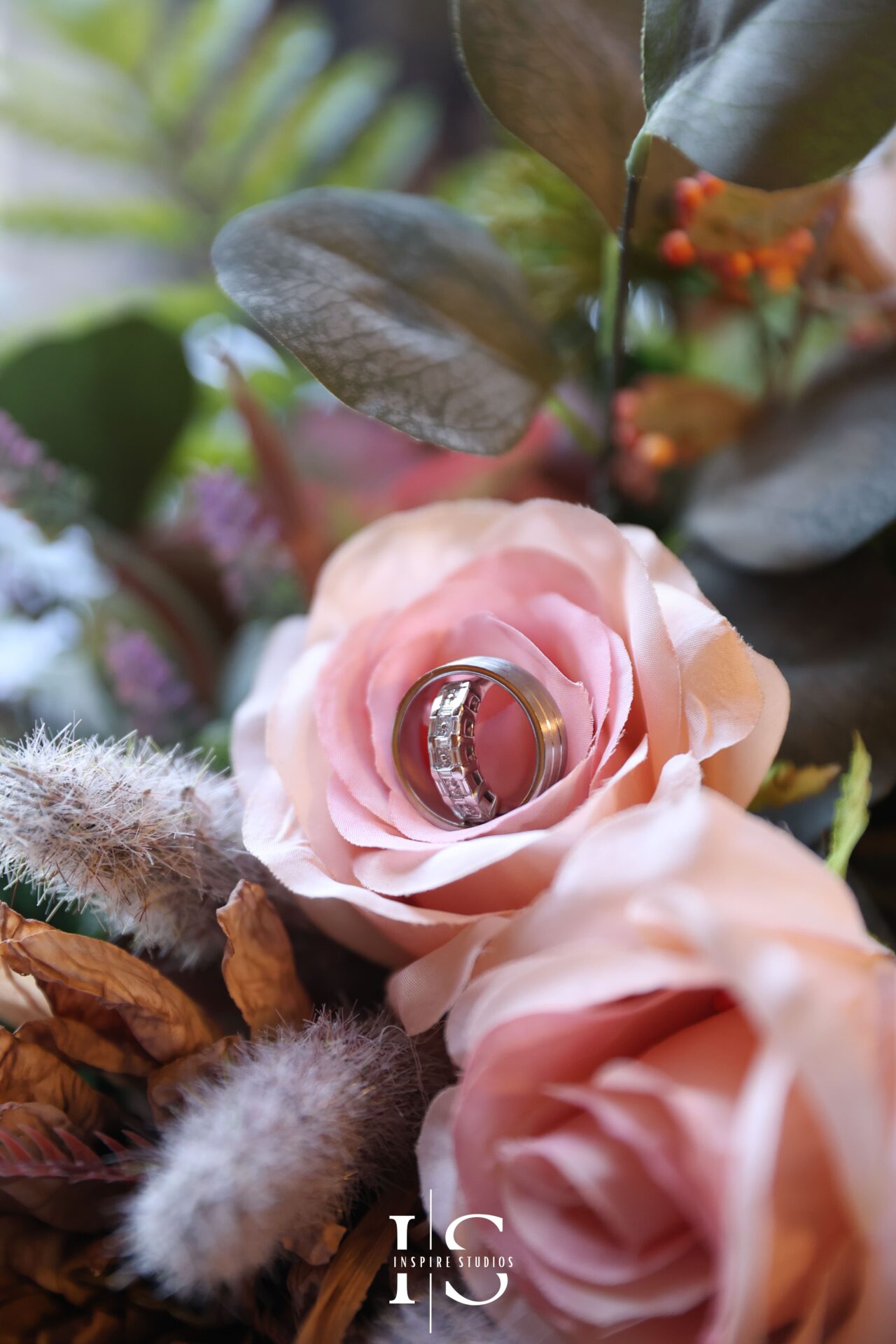 Wedding rings and bouquet arranged for detail shot