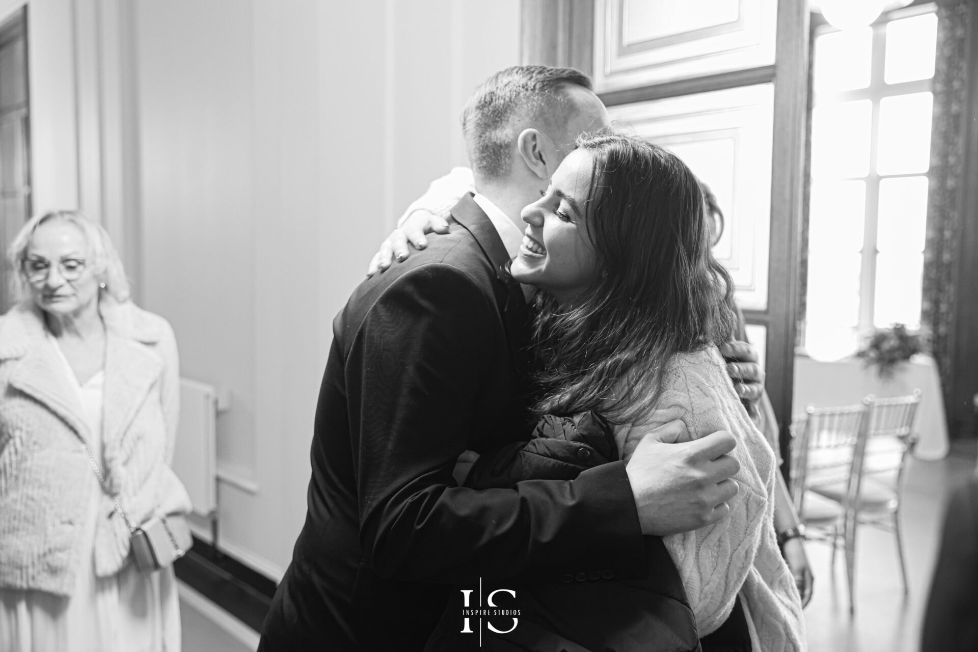 Bride and groom embrace outside London registry office