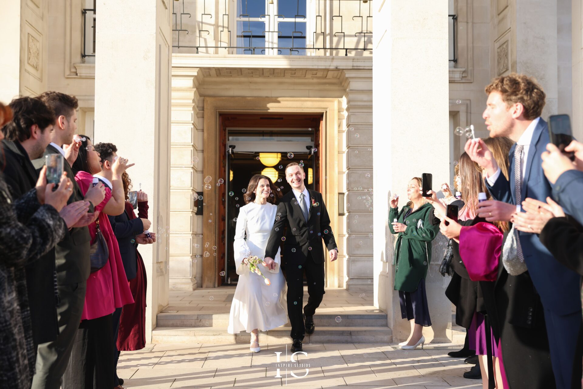 Emotional registry wedding exit with clapping guests at Walthamstow